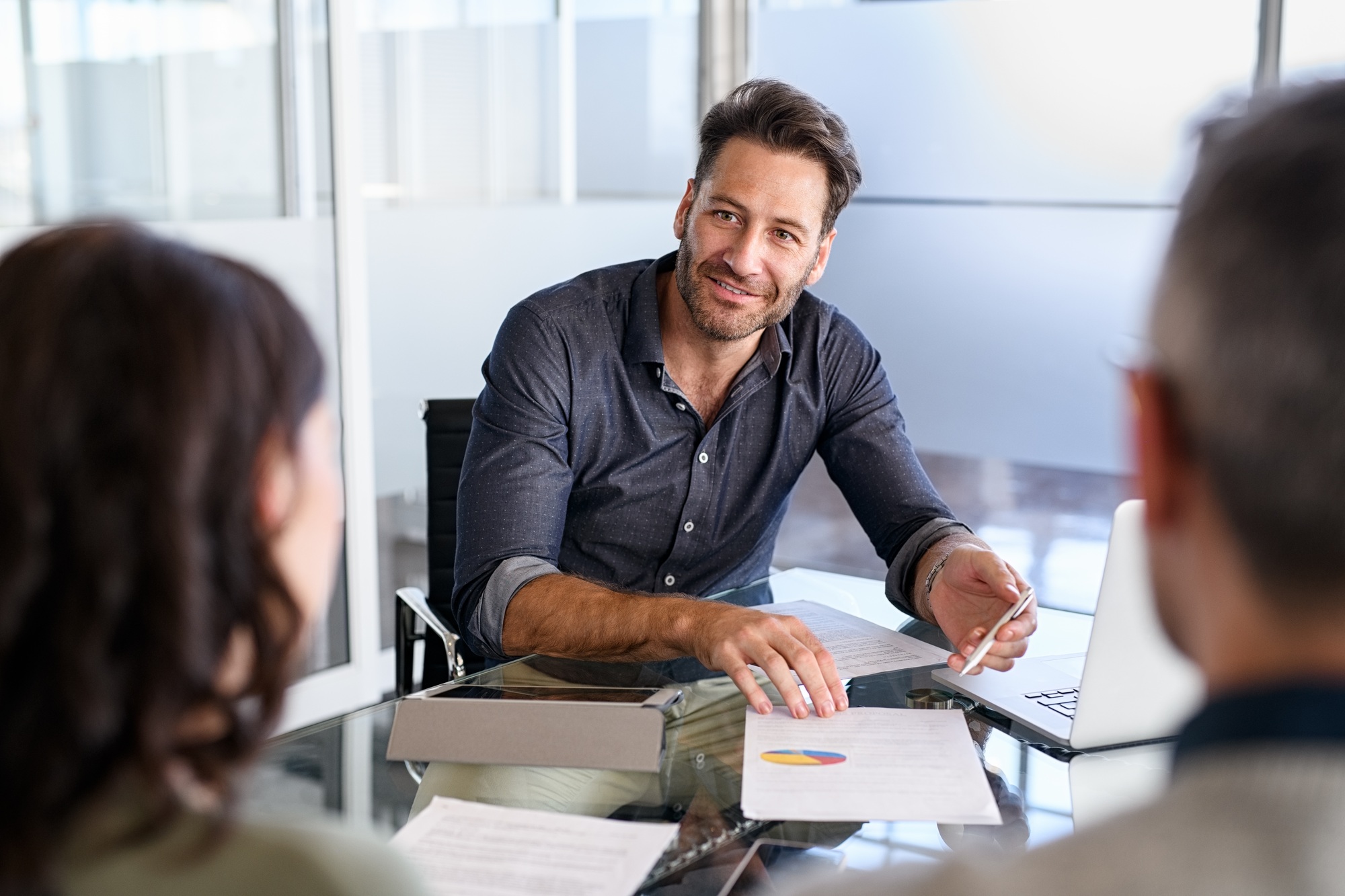 Confident businessman advising couple on finance