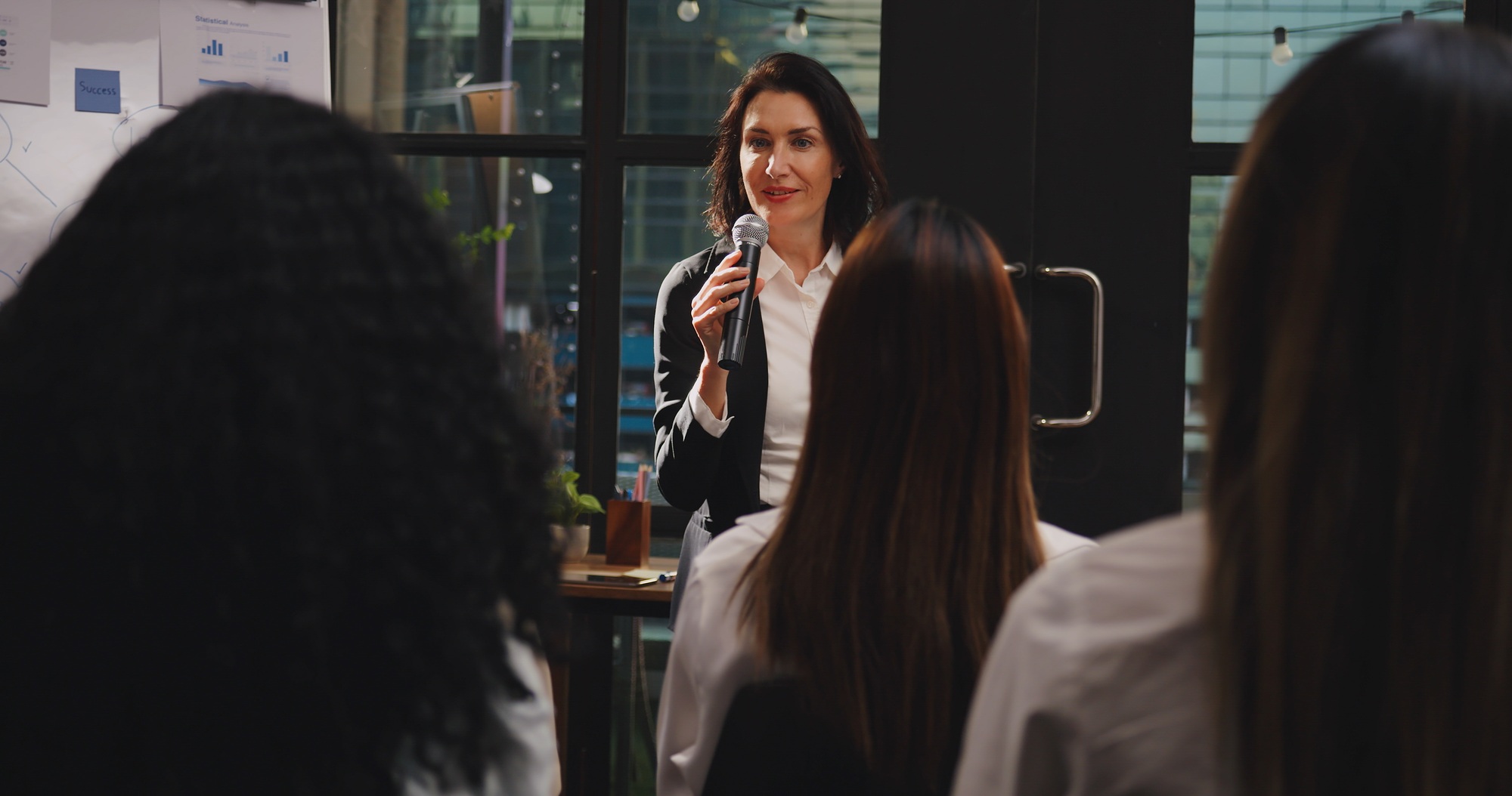 Confident  businesswoman or speaker sharing ideas with colleagues or audience