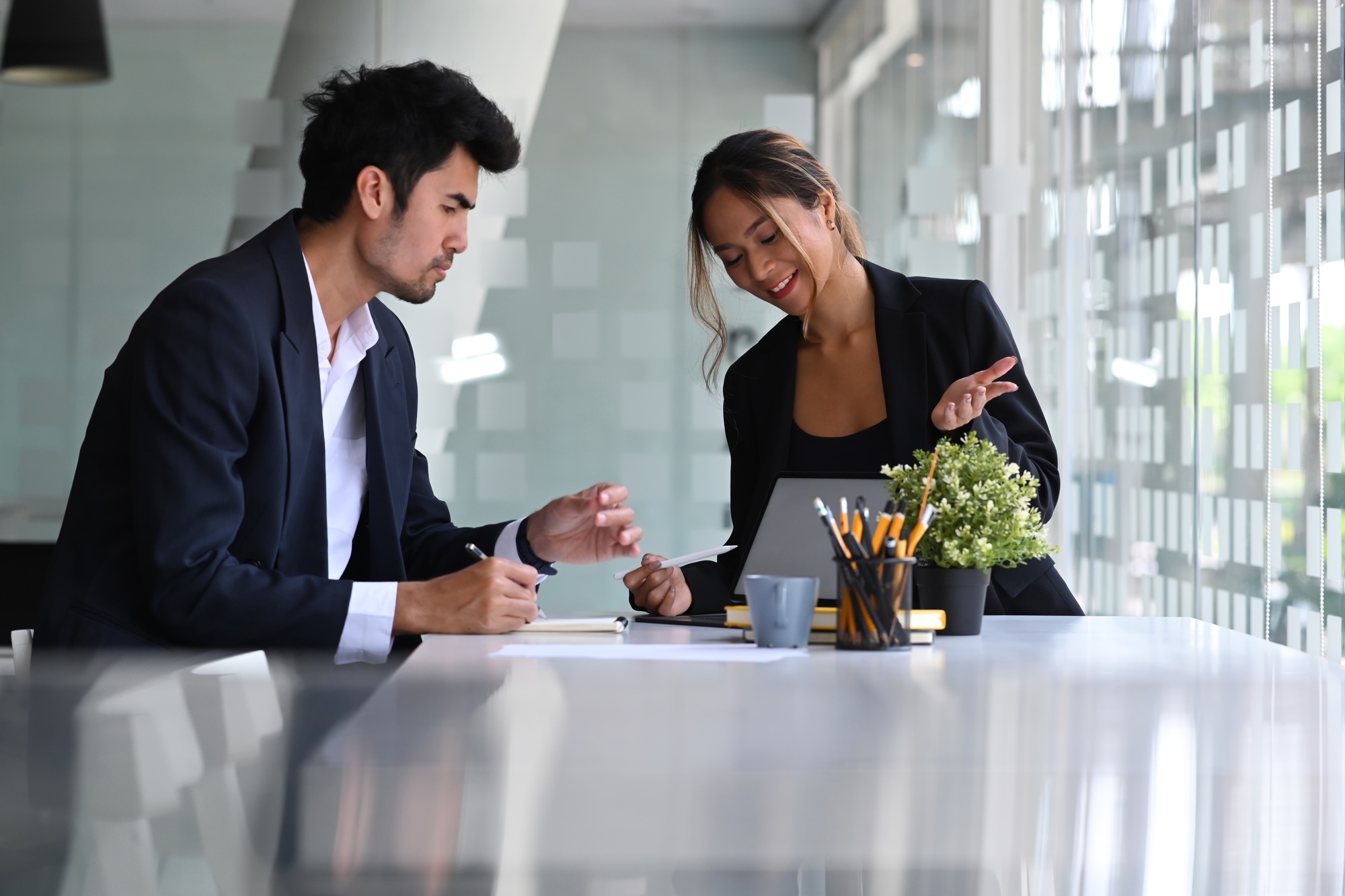Confident hr manager talking and introduction company to male applicant.