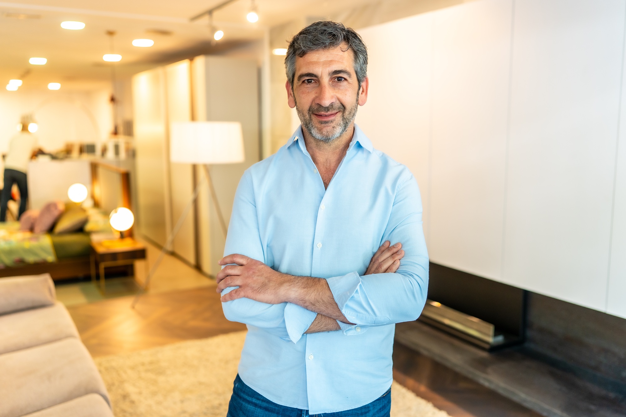 Confident salesperson posing in furniture store showroom