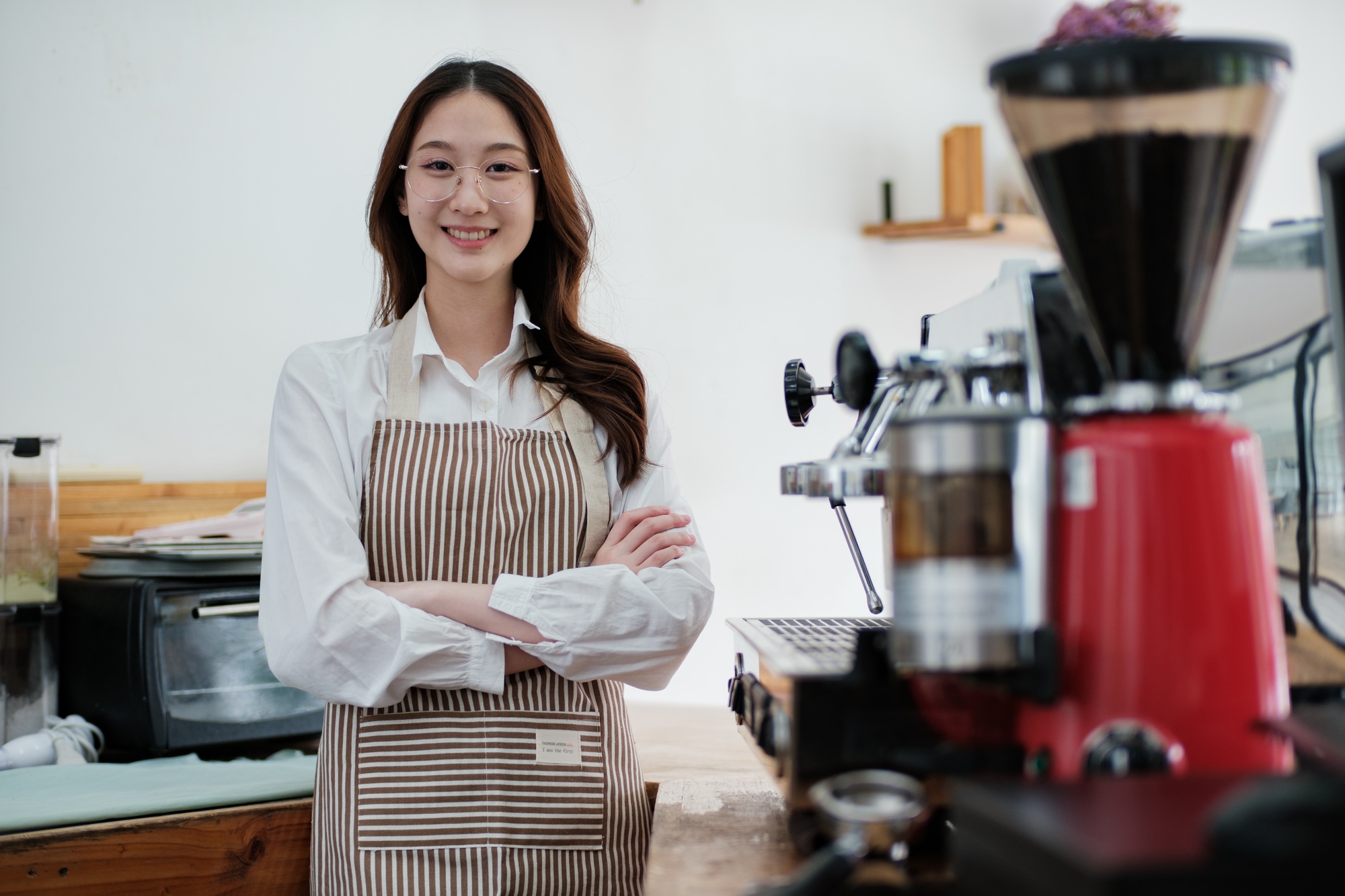 Confident small business owner at a cafe counter, radiating professionalism and hospitality.