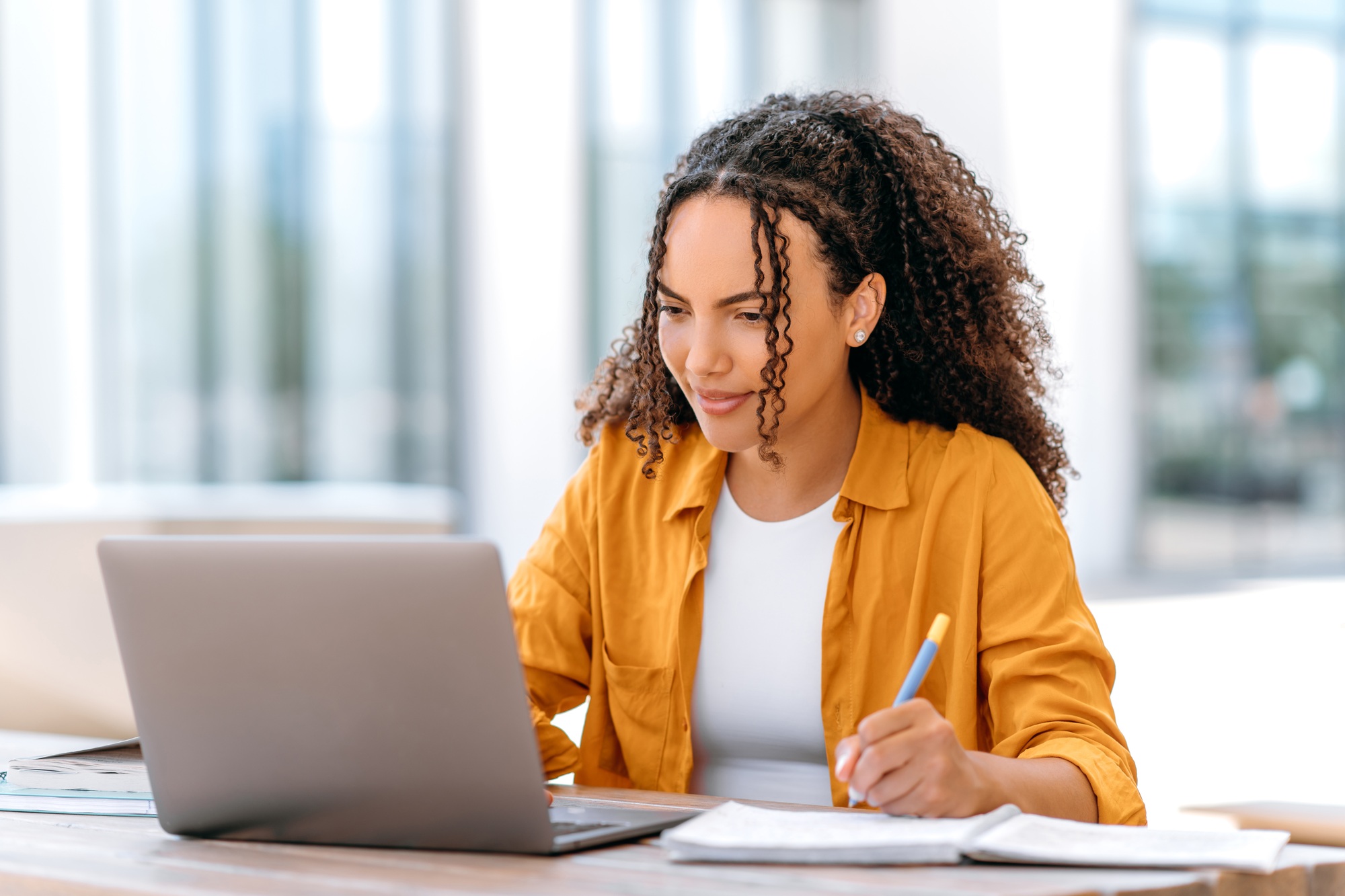 Confident successful smart curly haired girl, brazilian or hispanic nationality, freelancer worker