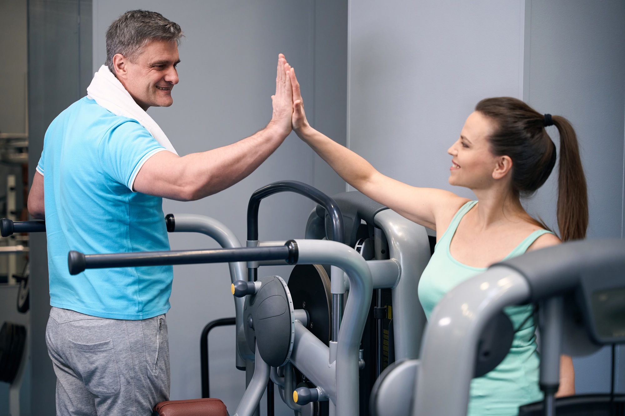Contented athletic woman greeting her training companion during workout