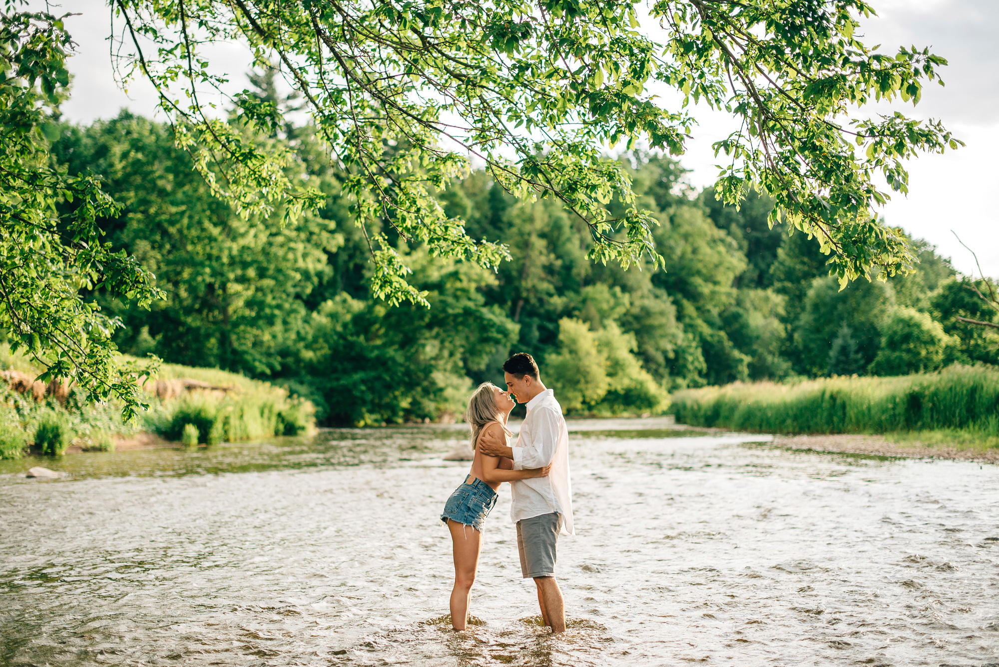 Couple embracing in a serene river setting
