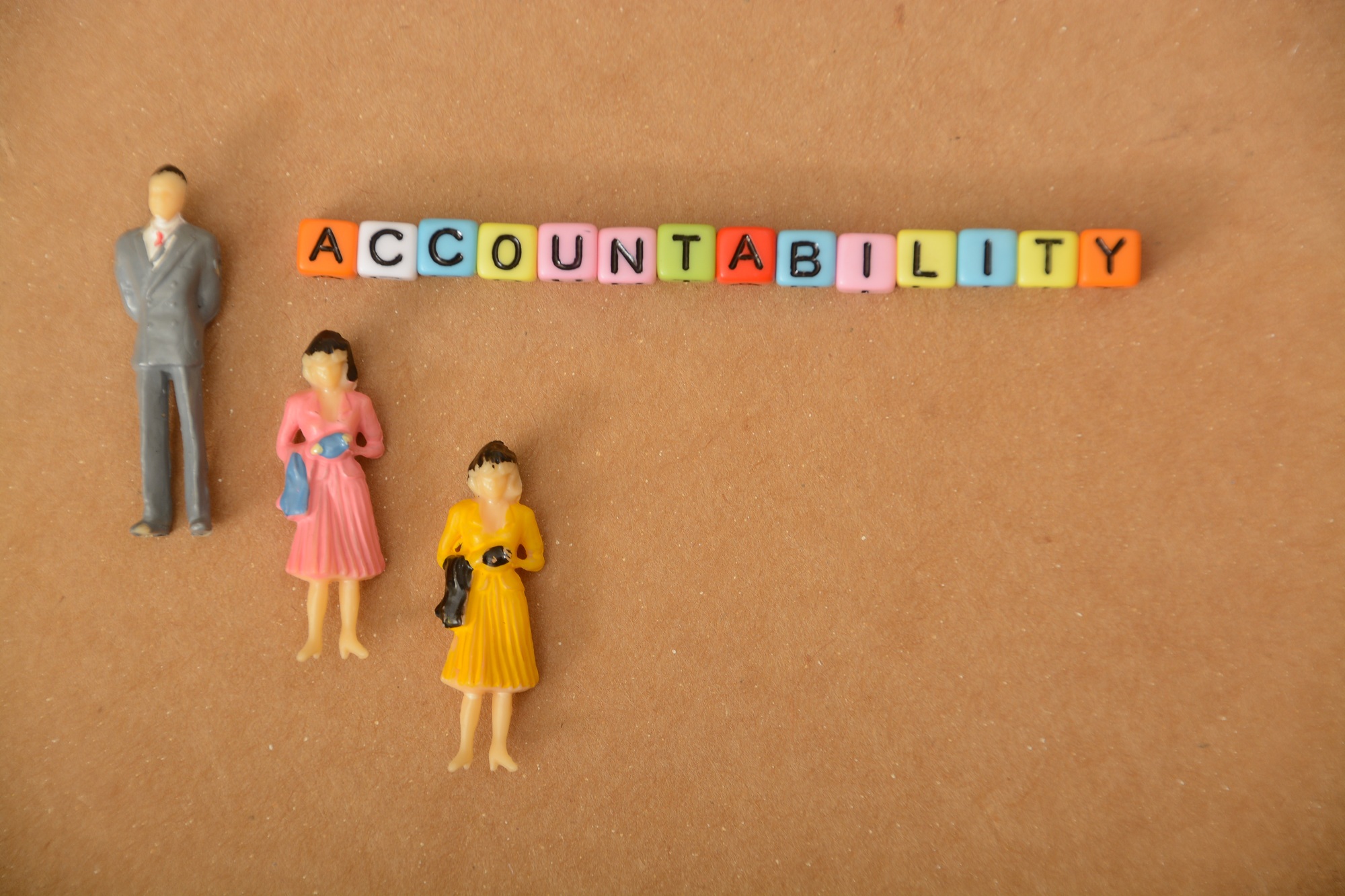 creatively people figures and arranged letters forming words related to the ACCOUNTABILITY.