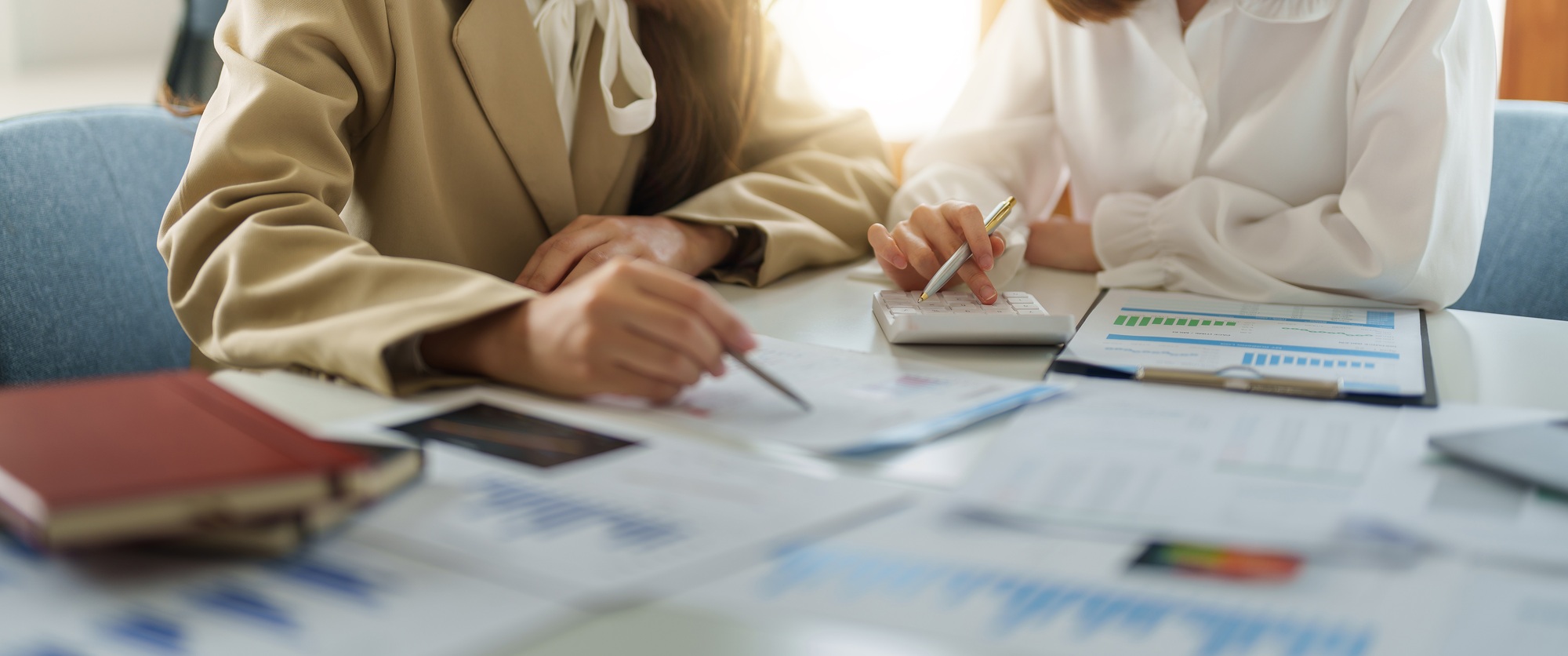 Crop image of business partnership coworkers using a calculator analysis graph company financial