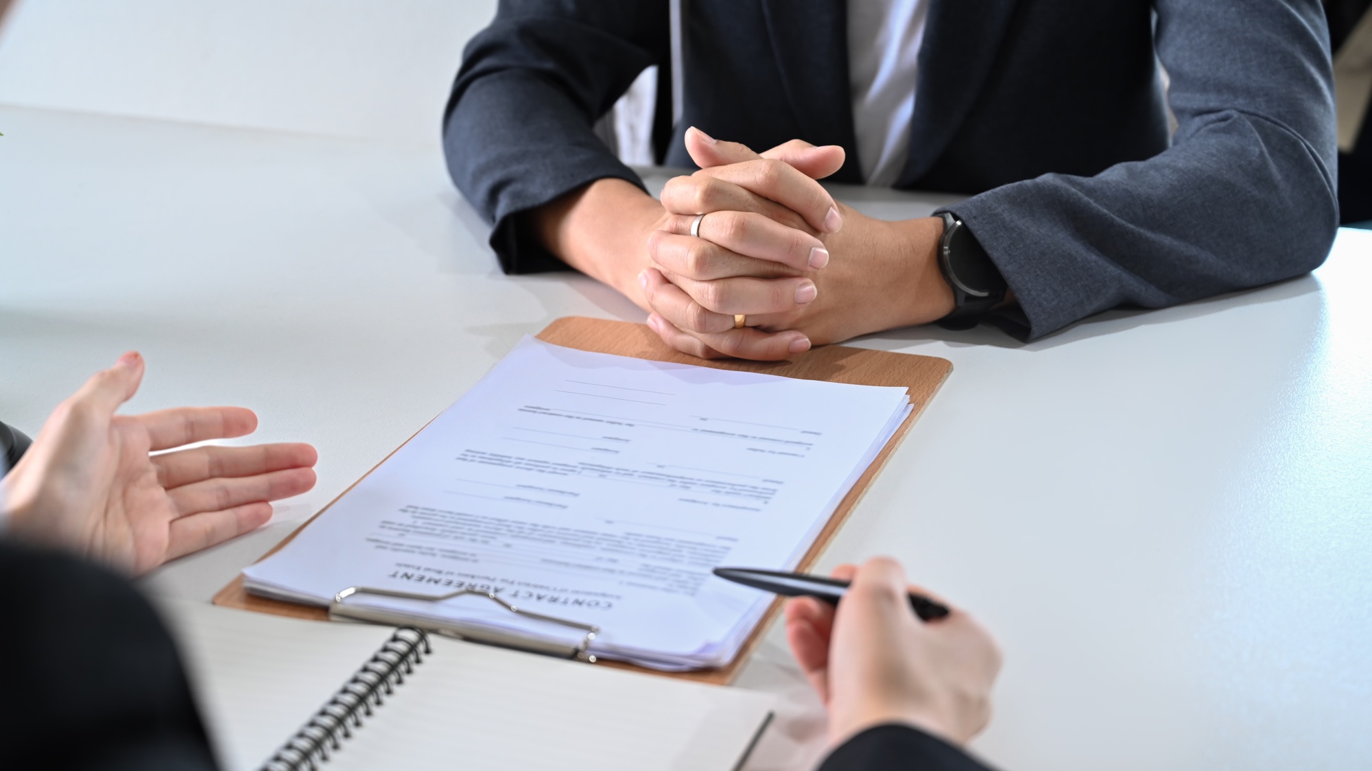 Cropped view of attorney or lawyers talking to her clients for providing law consultation.