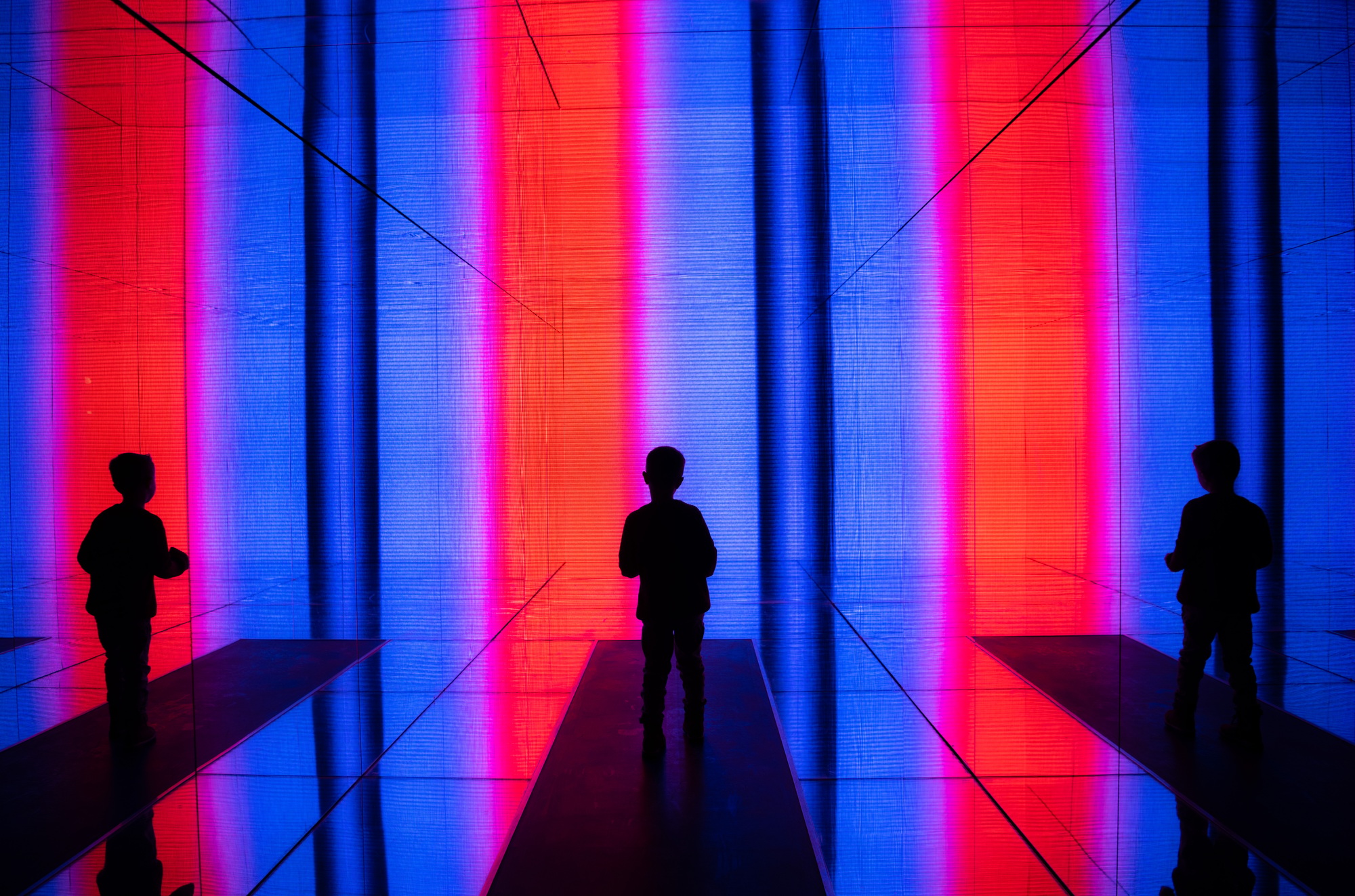 Data visualization. A boy stands in front of a huge light screen