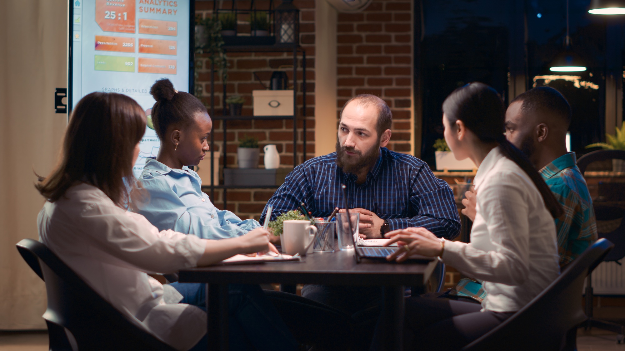 Diverse coworkers brainstorming, team leader explaining strategy plan