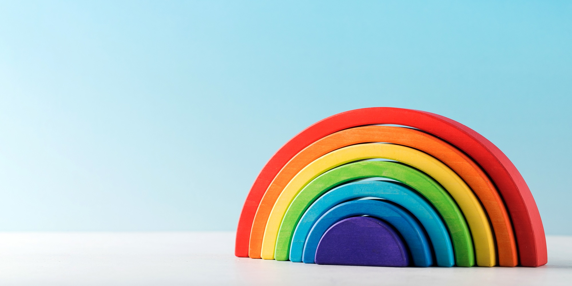 Eco friendly wooden rainbow toy for early childhood development.