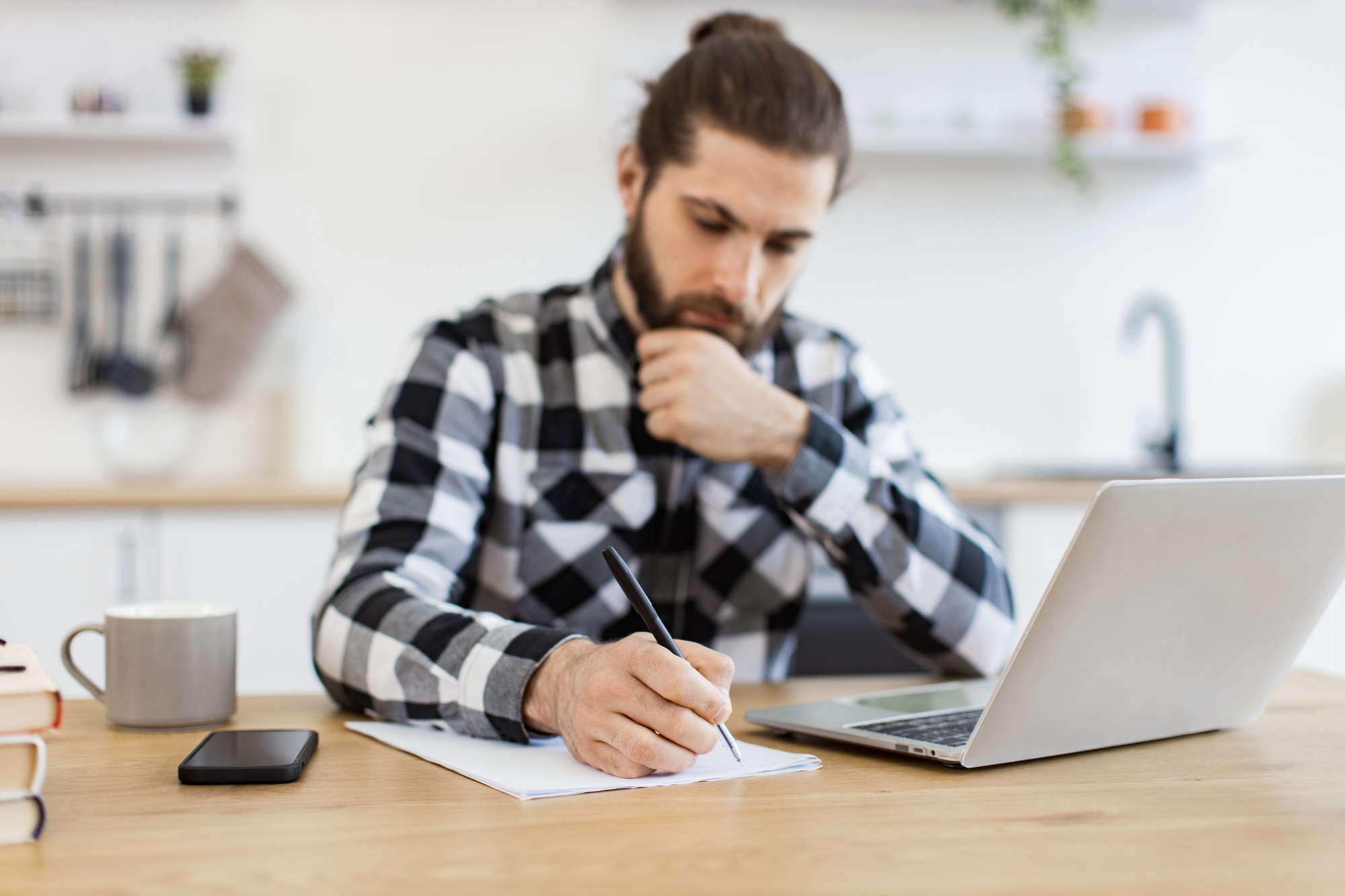 Efficient business owner improving contract while checking data on computer.