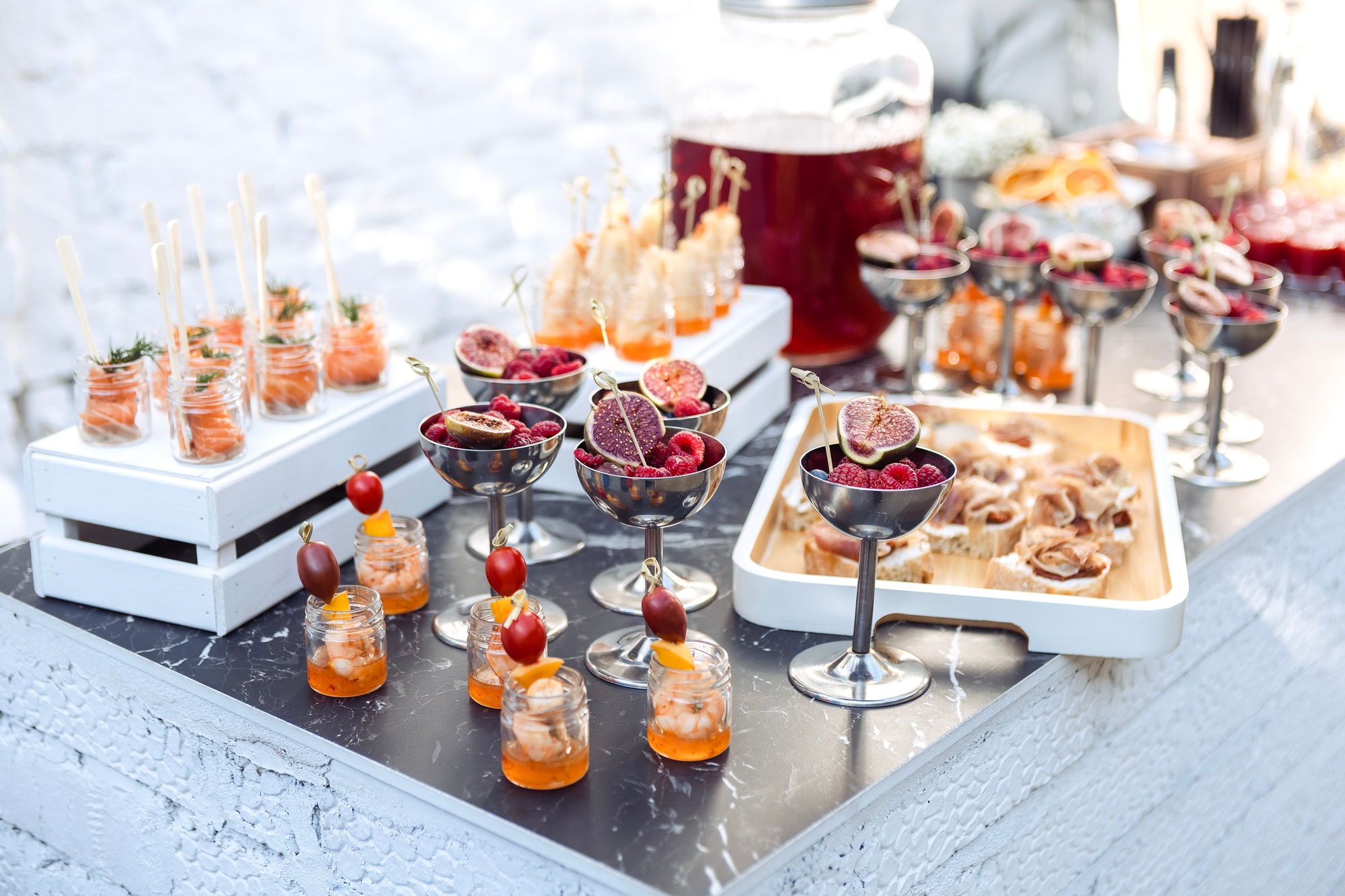 Elegant catering setup with glasses of figs and berries on display