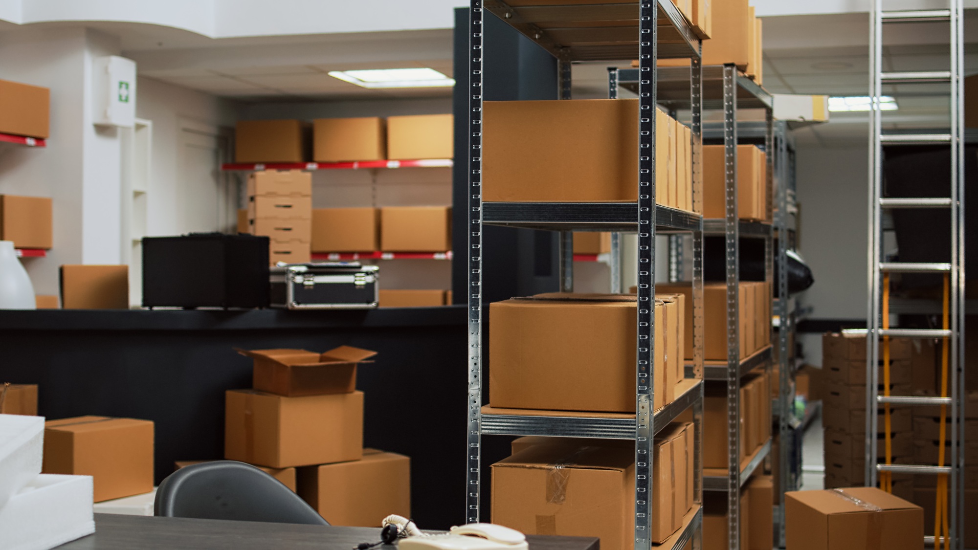Empty storehouse with office desk and goods