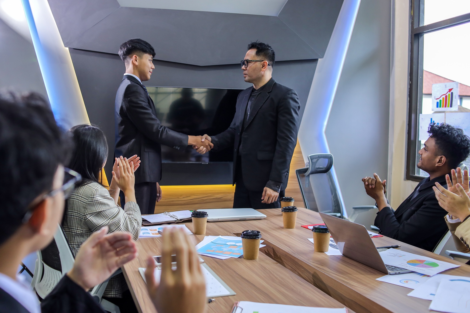 Excited worker getting promotion, recognition, respect and applause of colleagues.