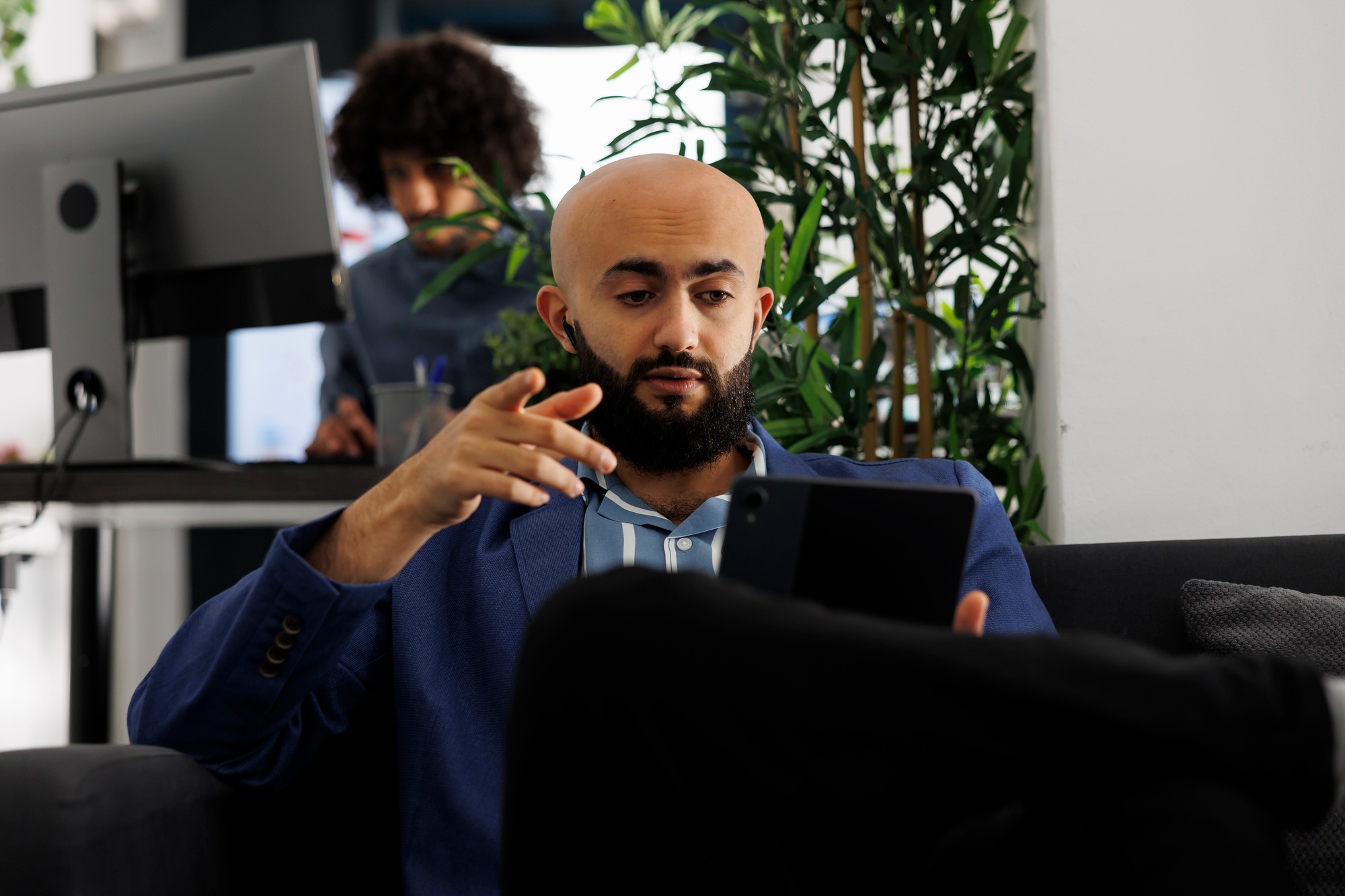 Executive discussing sales strategy using video conference on tablet