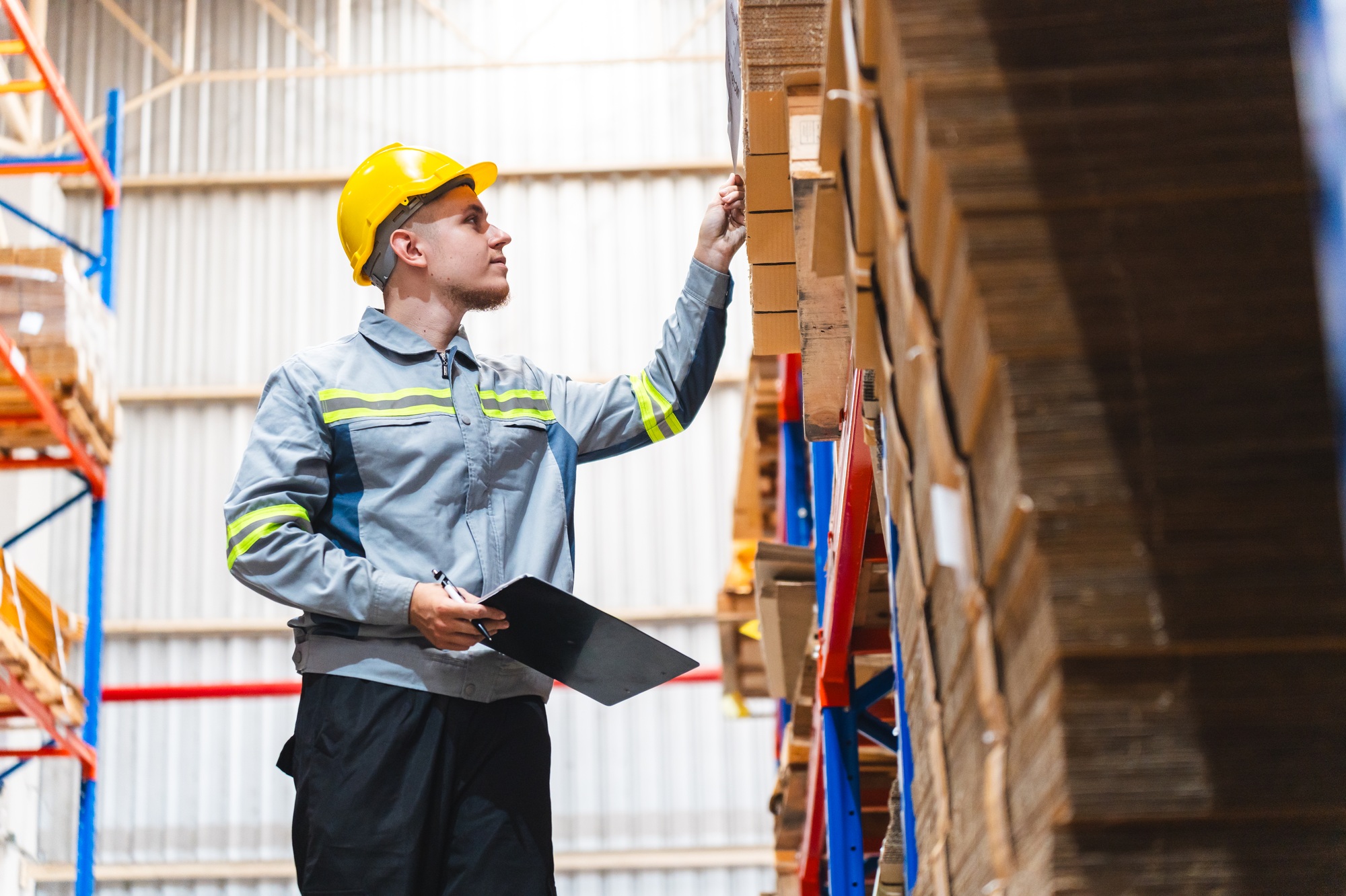 Factory manager, foreman worker checking stock inventory on good shelf in delivery storehouse