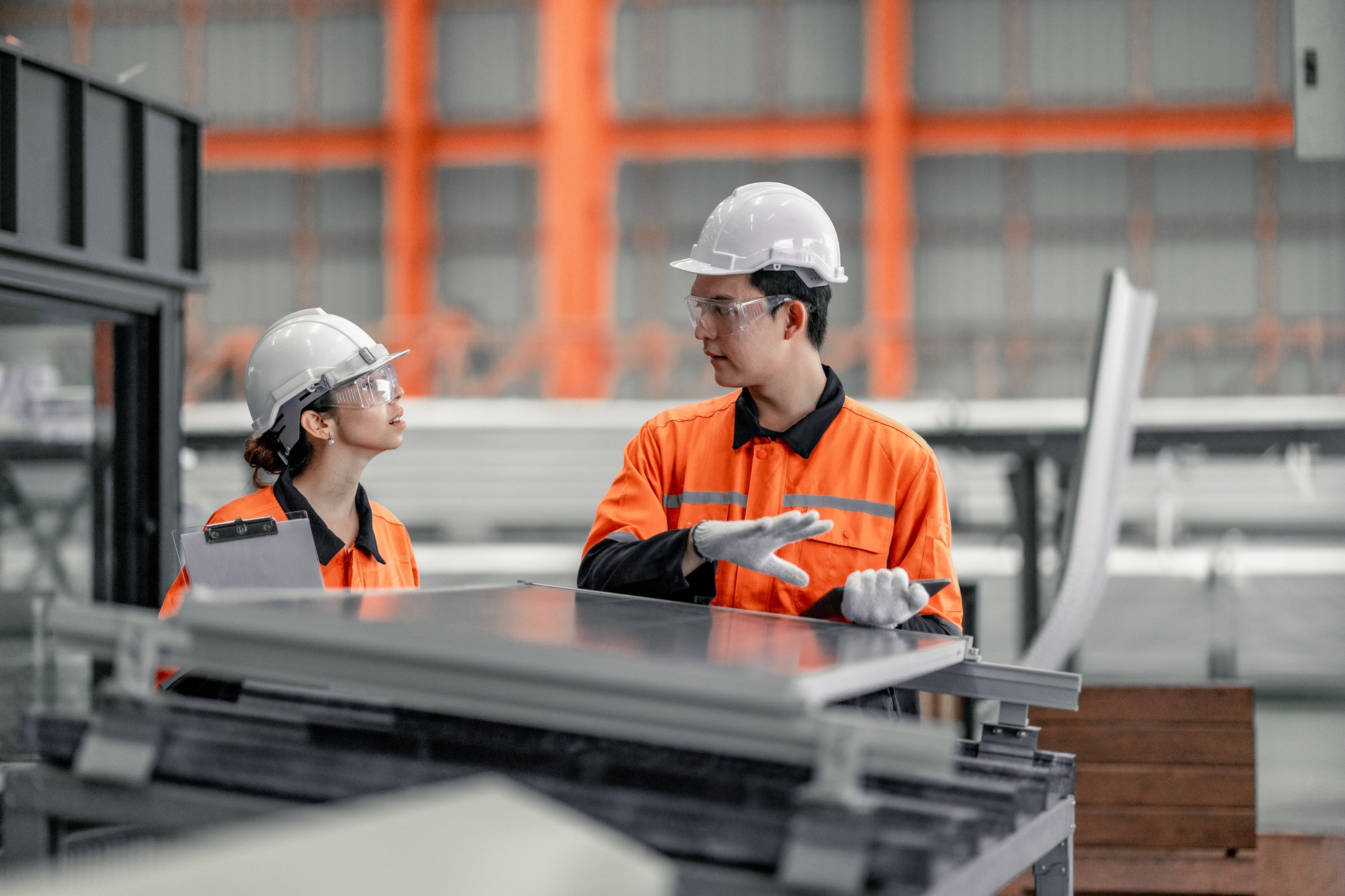 Factory metal workers install solar panels, cut costs, earn carbon credits, combat climate change.