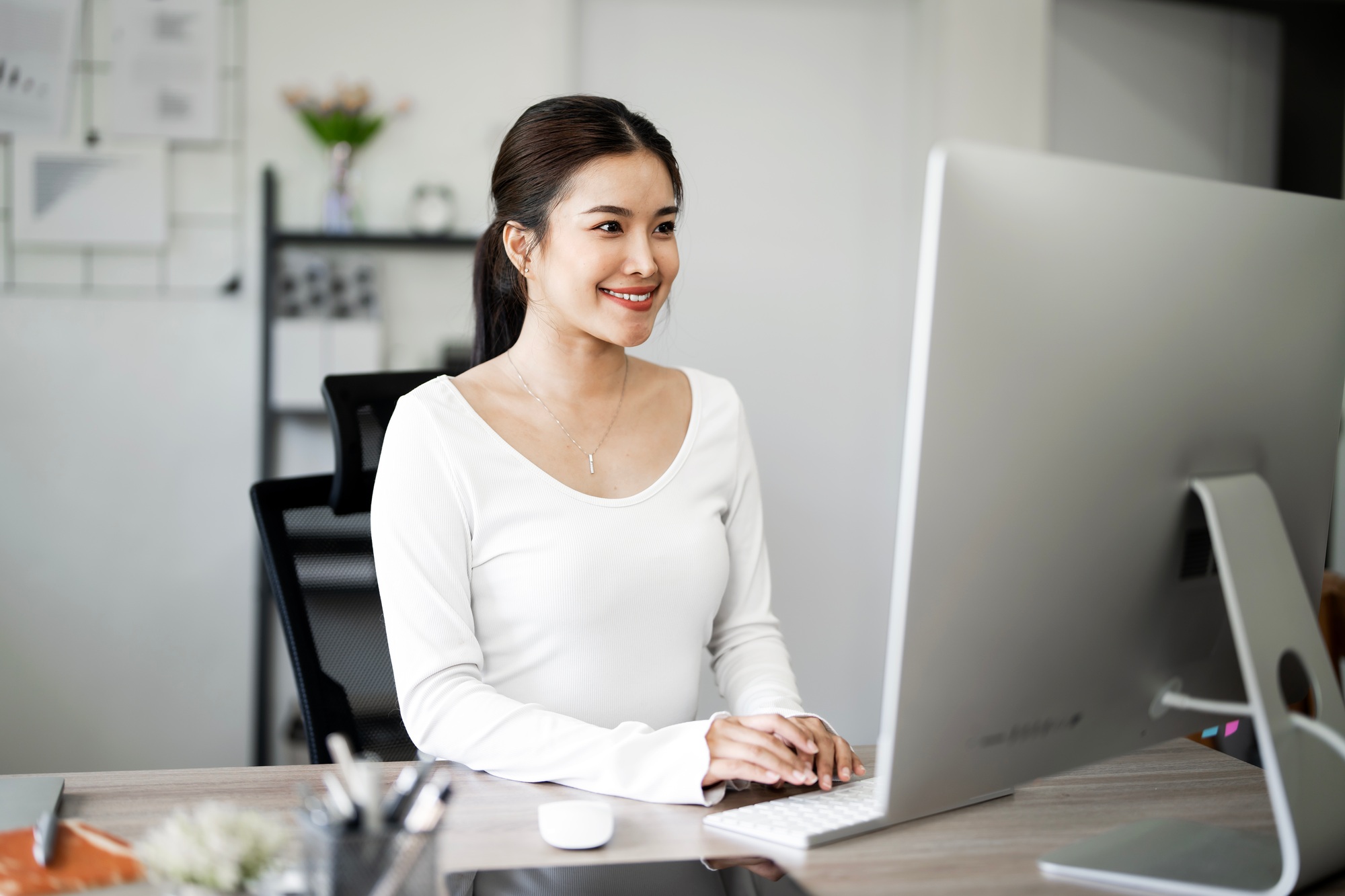 Female graphic designer working with computer at table in home office