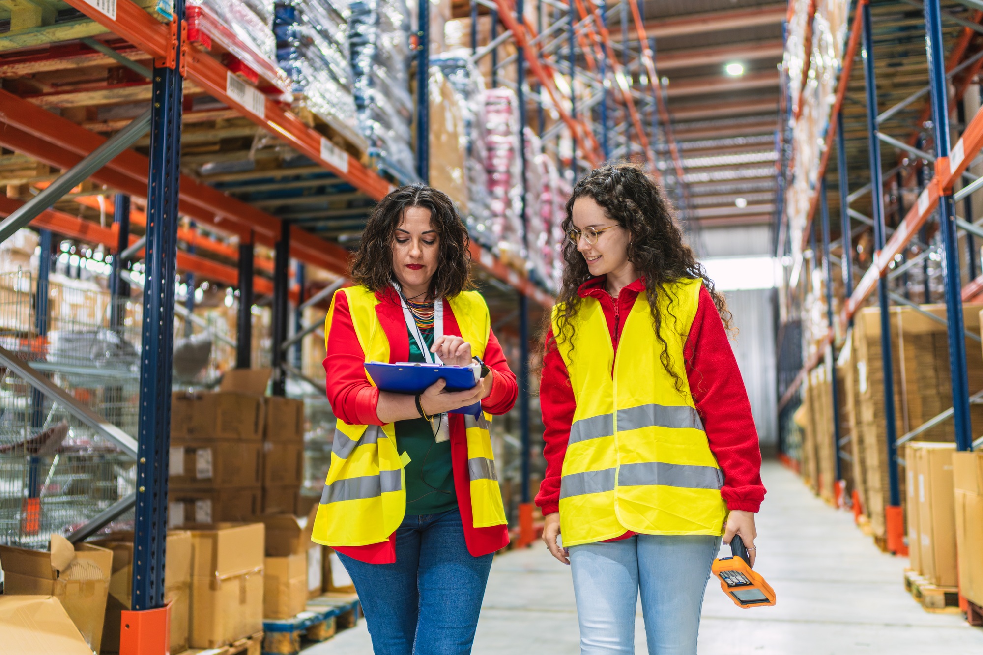 Female workers managing inventory and logistics in warehouse