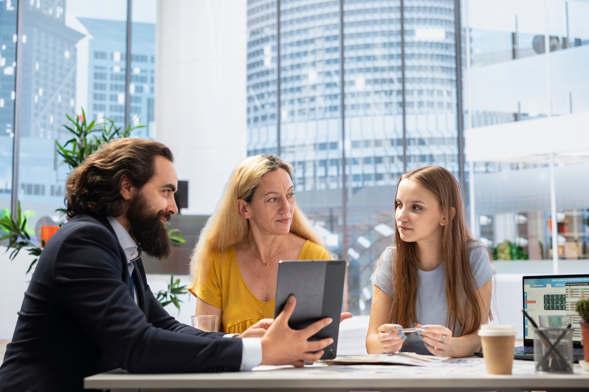 Financial advisor uses software on tablet to calculate clients net worth