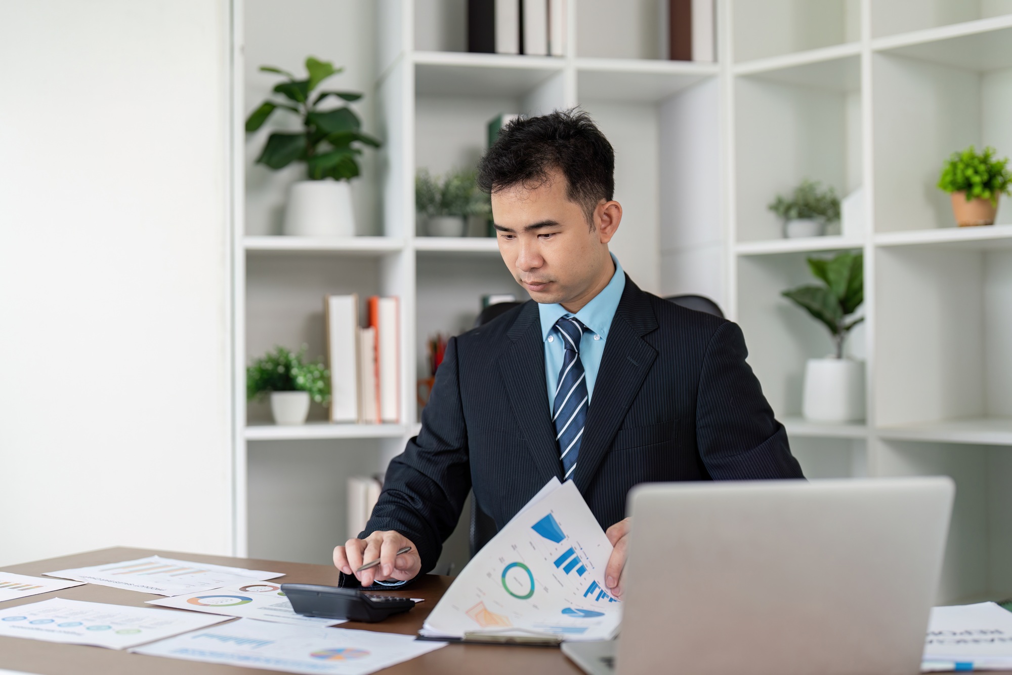 Financial Analyst Reviewing Business Reports for Strategic Planning