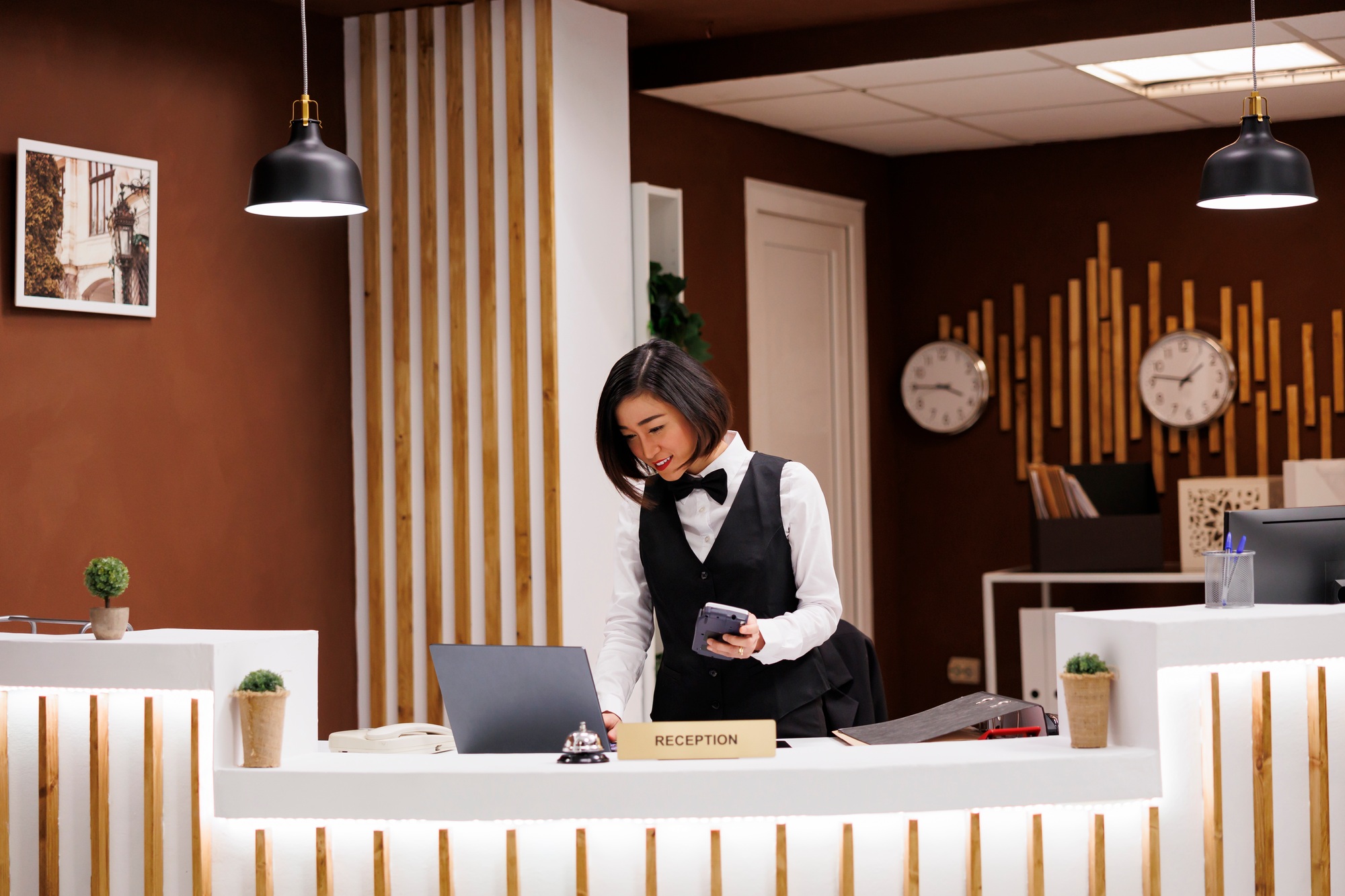 Front desk staff holding pos terminal