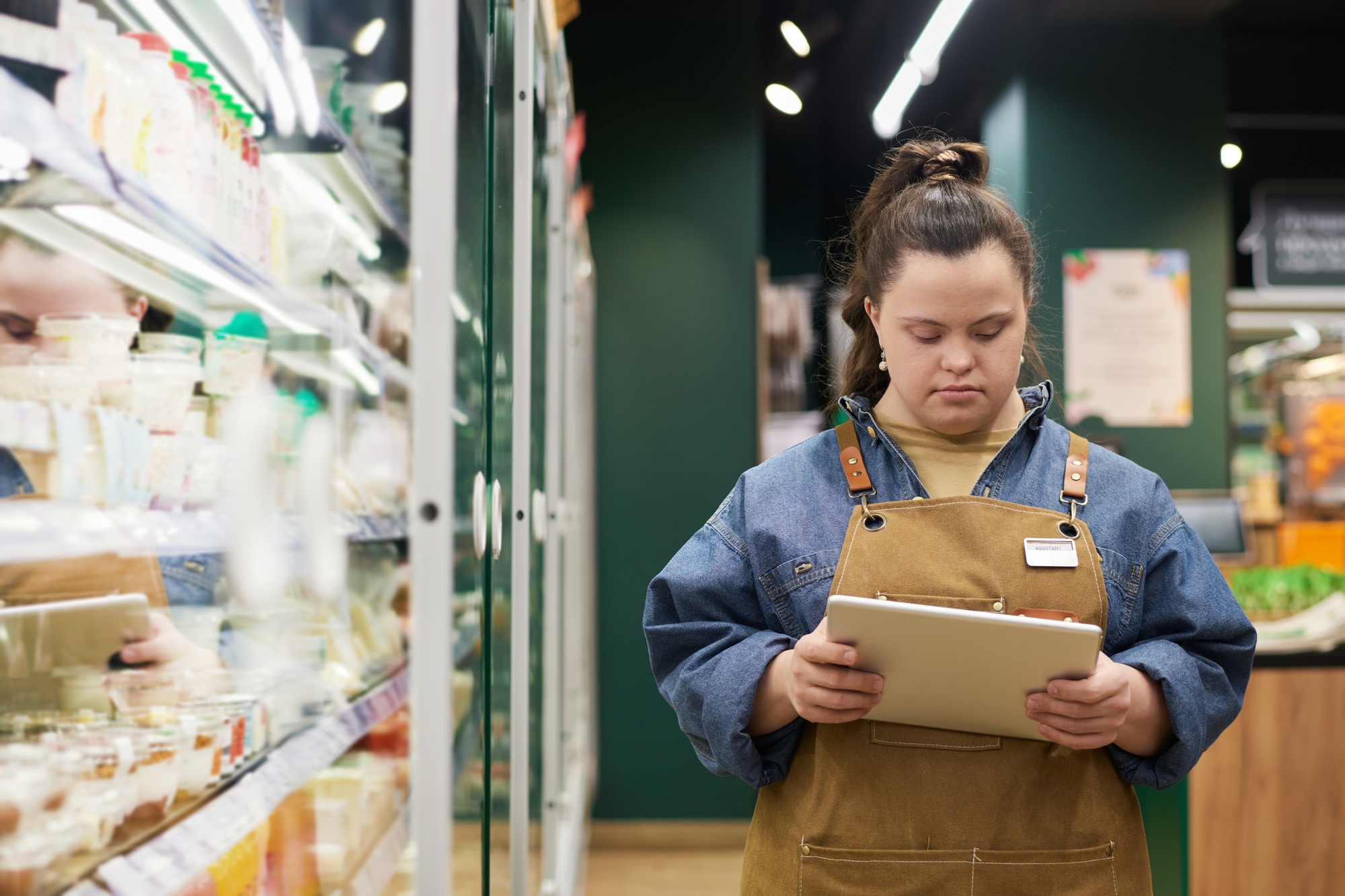 Girl with Disability Working in Supermarket Doing Stock Review