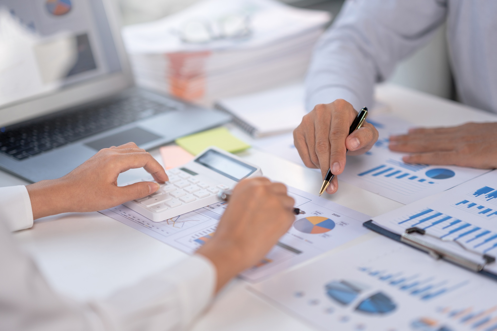 group of business meeting to discuss plan analyze graph and chart and calculate company performance,