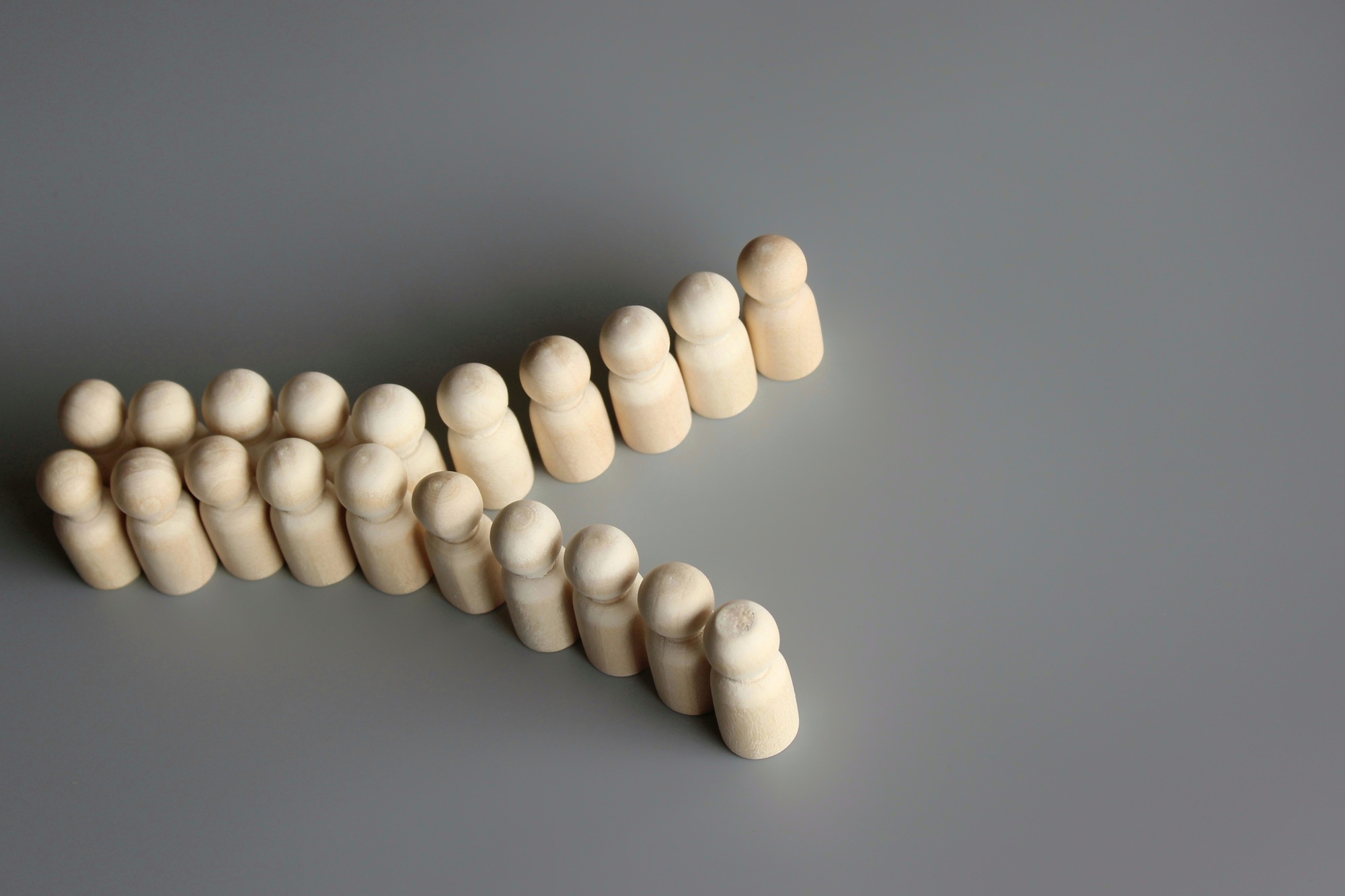 Group of people figures divide into two.