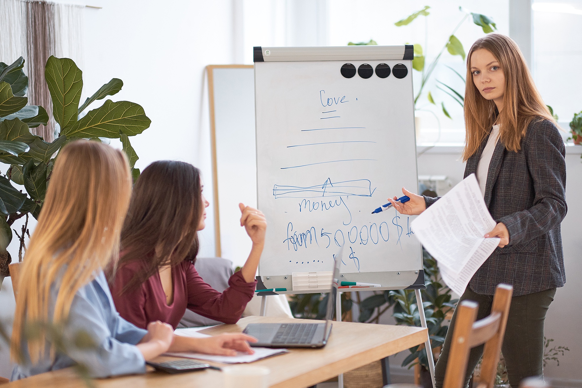 group of women are discussing business strategies together.