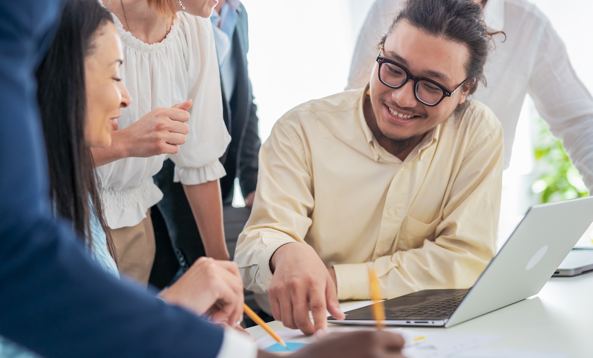Group of young business people analyzing data using computer and studying new business plan