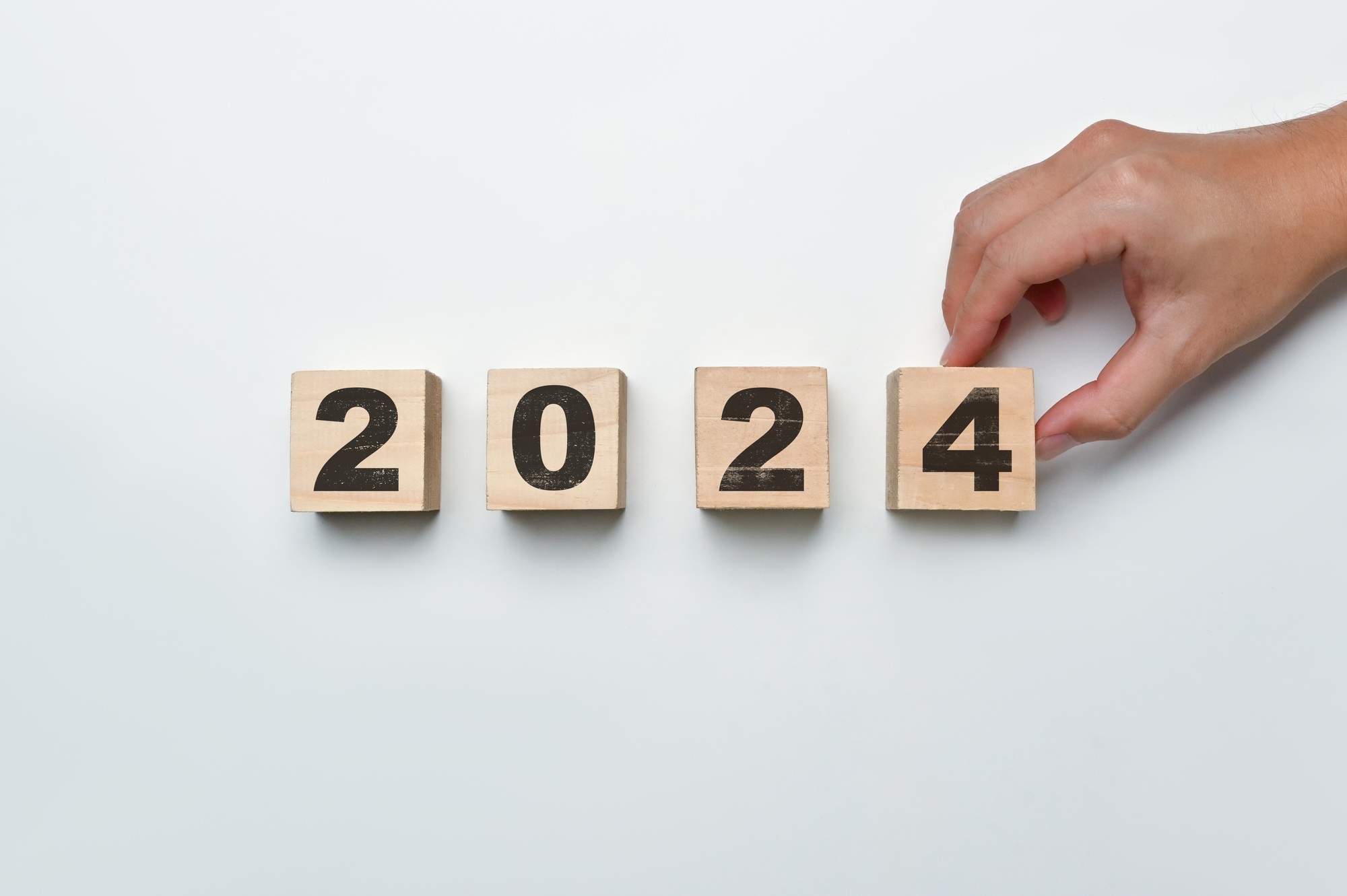 Hand flipping wooden block cube to 2024