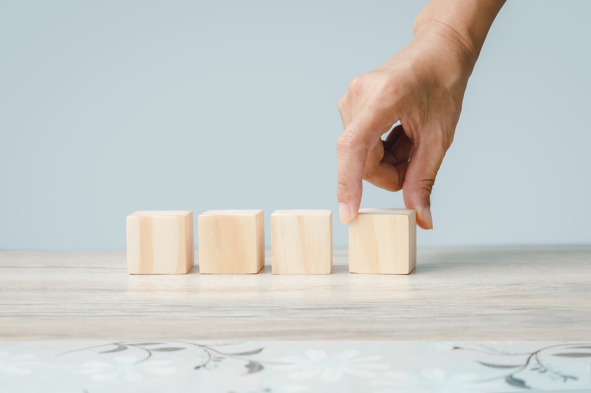 Hand holding wood cube block business development concept