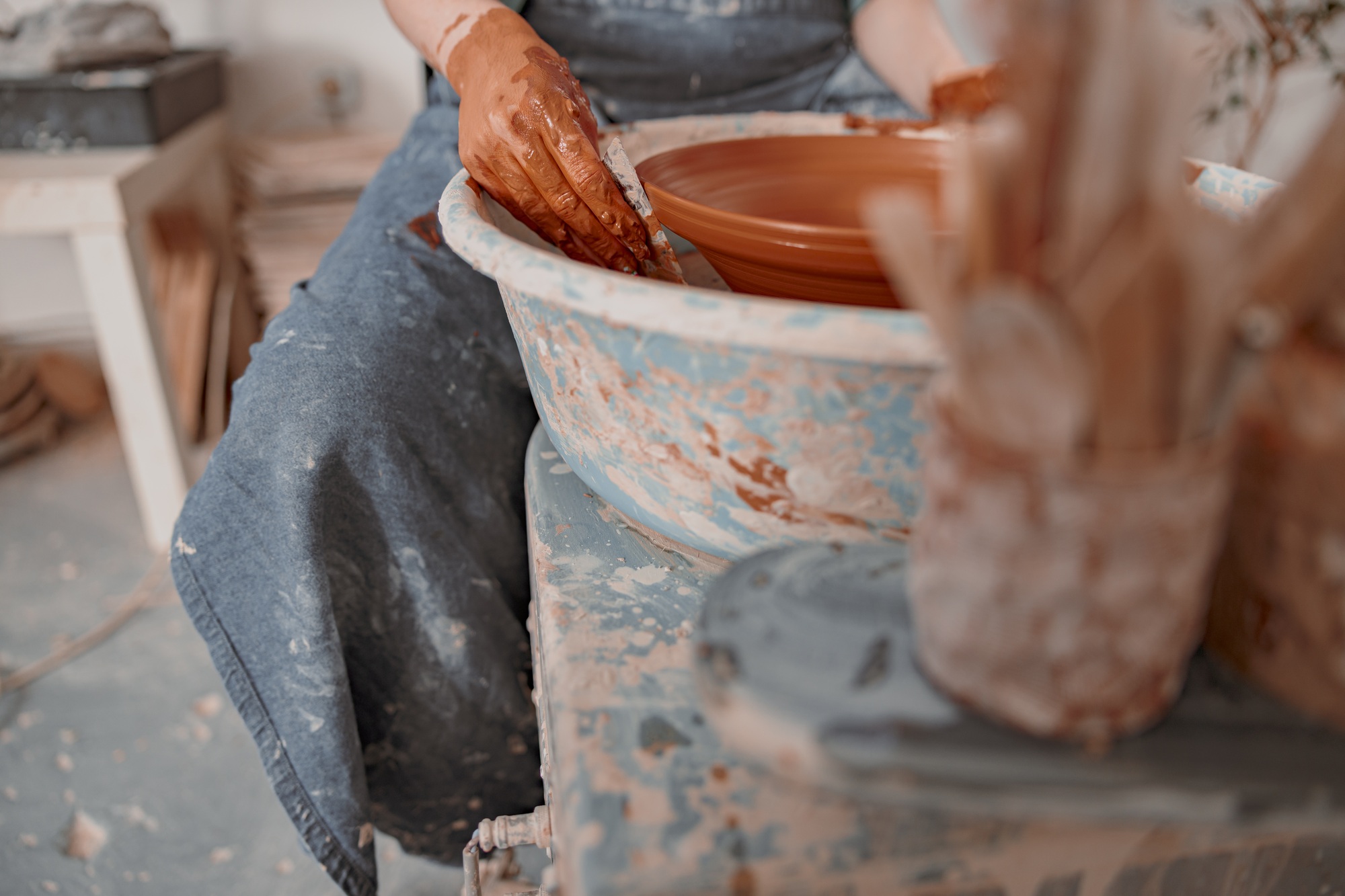 Handmade artist working with clay in craft room