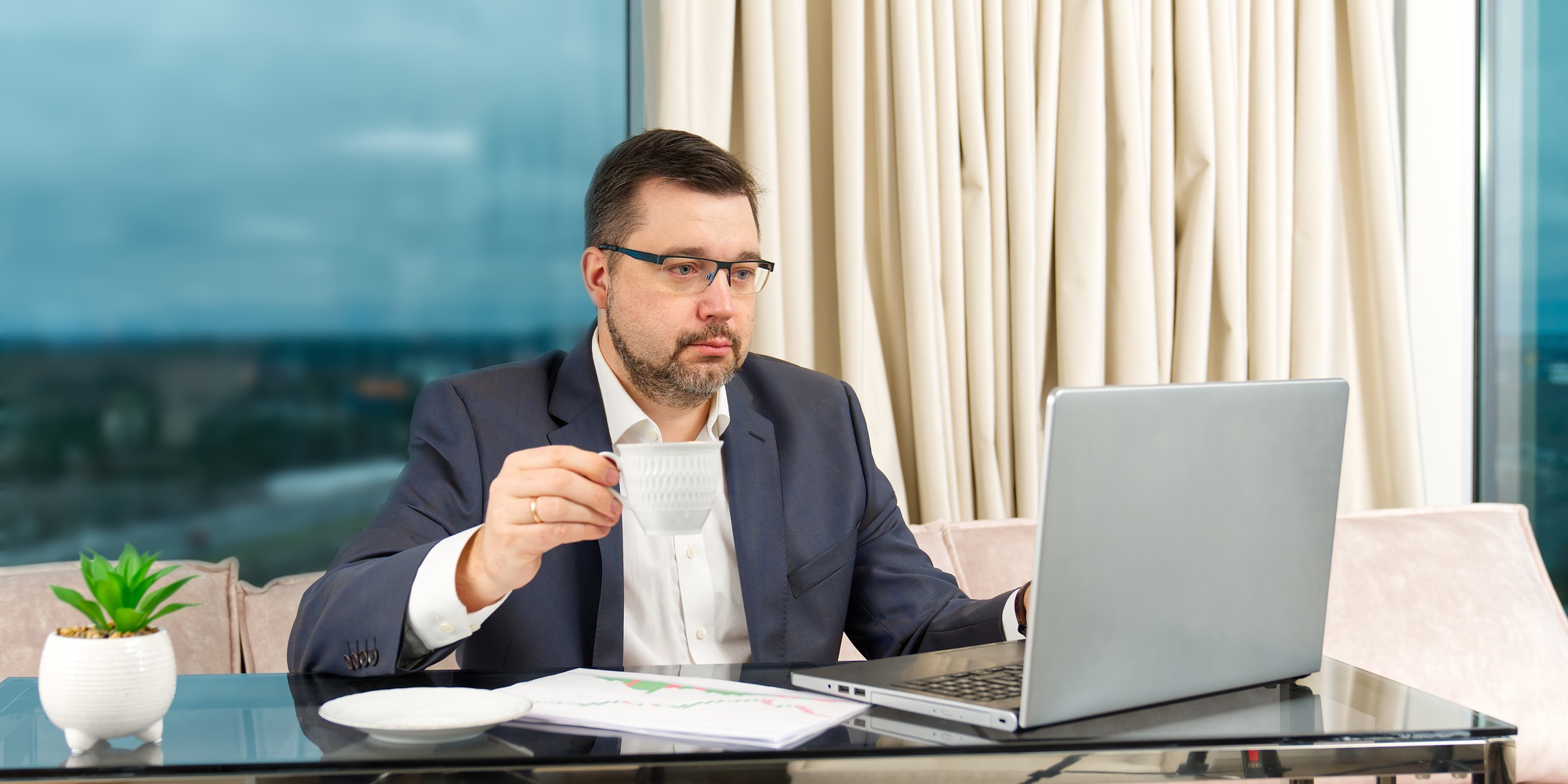 Happy businessman working on laptop in home office. financial investor working in the office