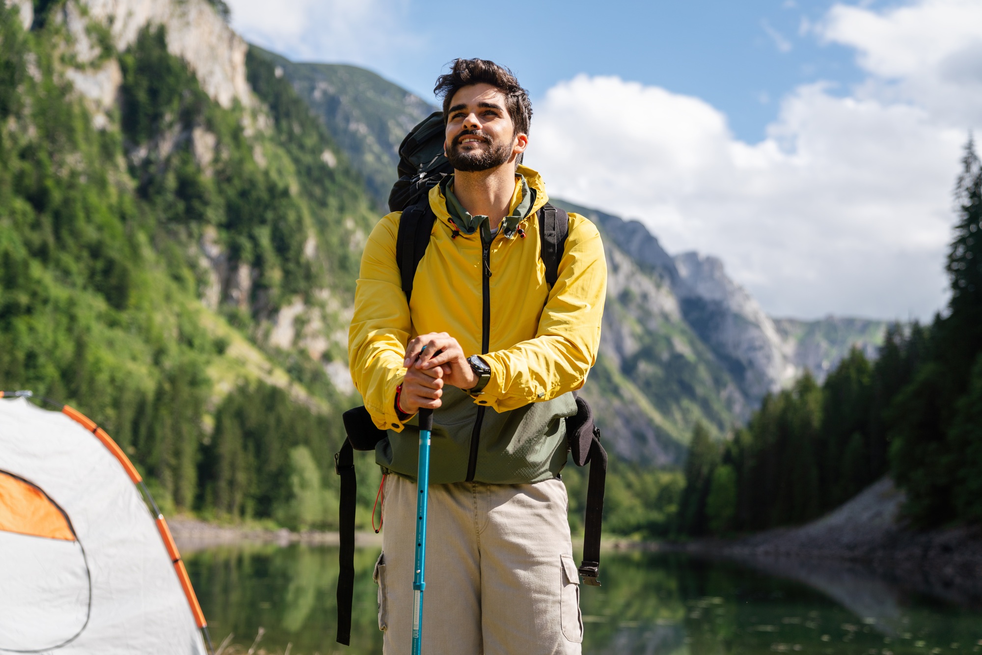 Happy hiker winning reaching life goal, success, freedom and happiness, achievement in mountains