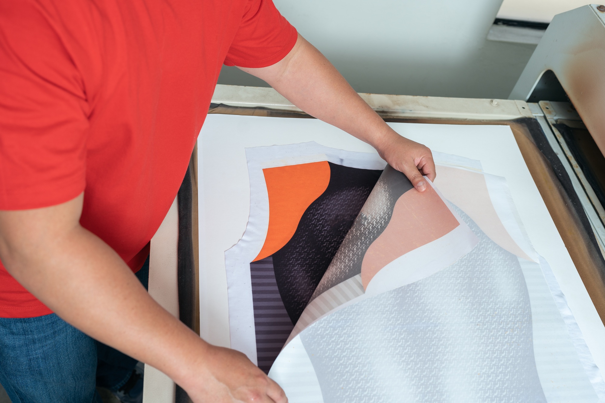 High angle view of an unrecognizable man working with a garment print