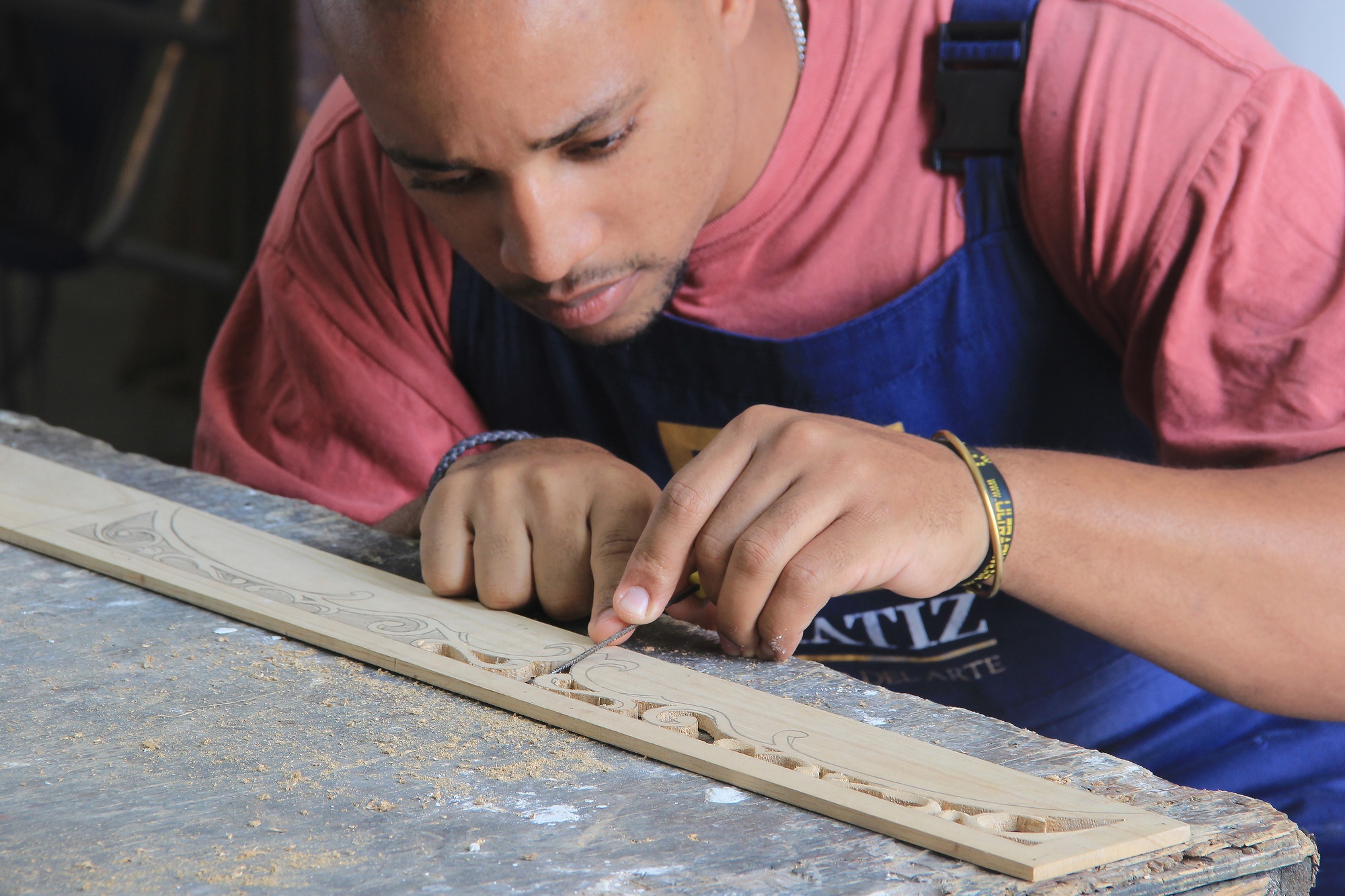 Hispanic male restoring some vintage furniture in Cuba