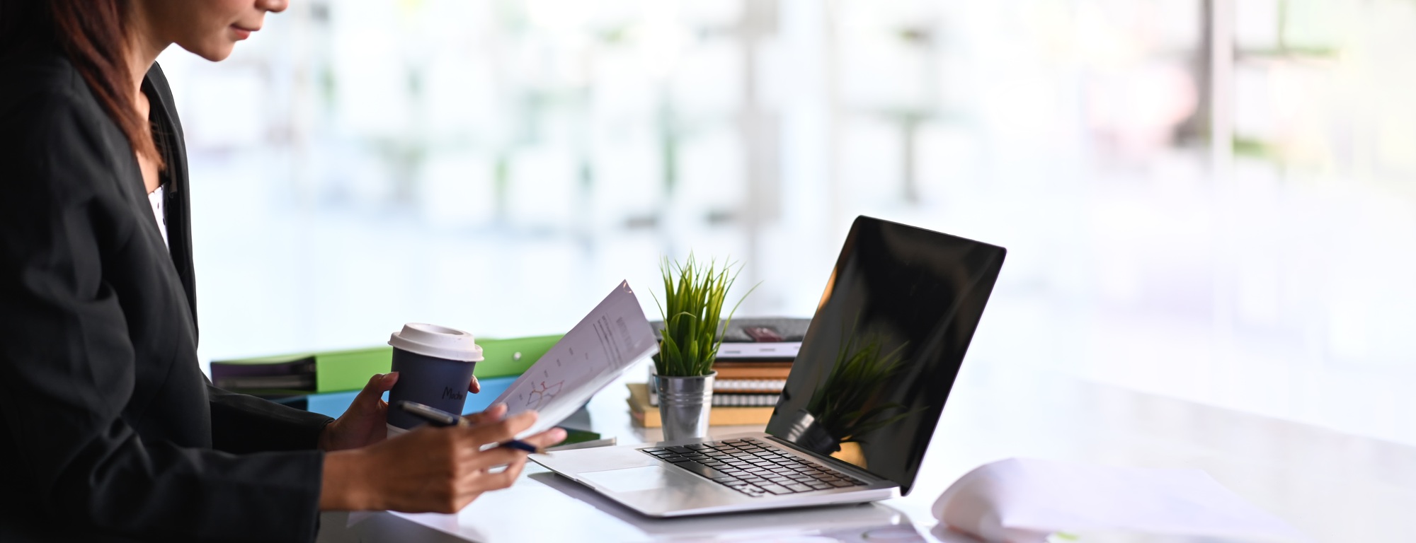 Horizontal photo of businesswoman analyzing company financial report balance sheet statement.