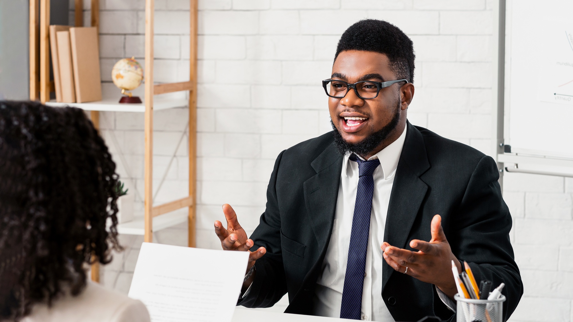 Human resources manager communicating with positive vacancy applicant on employment interview at
