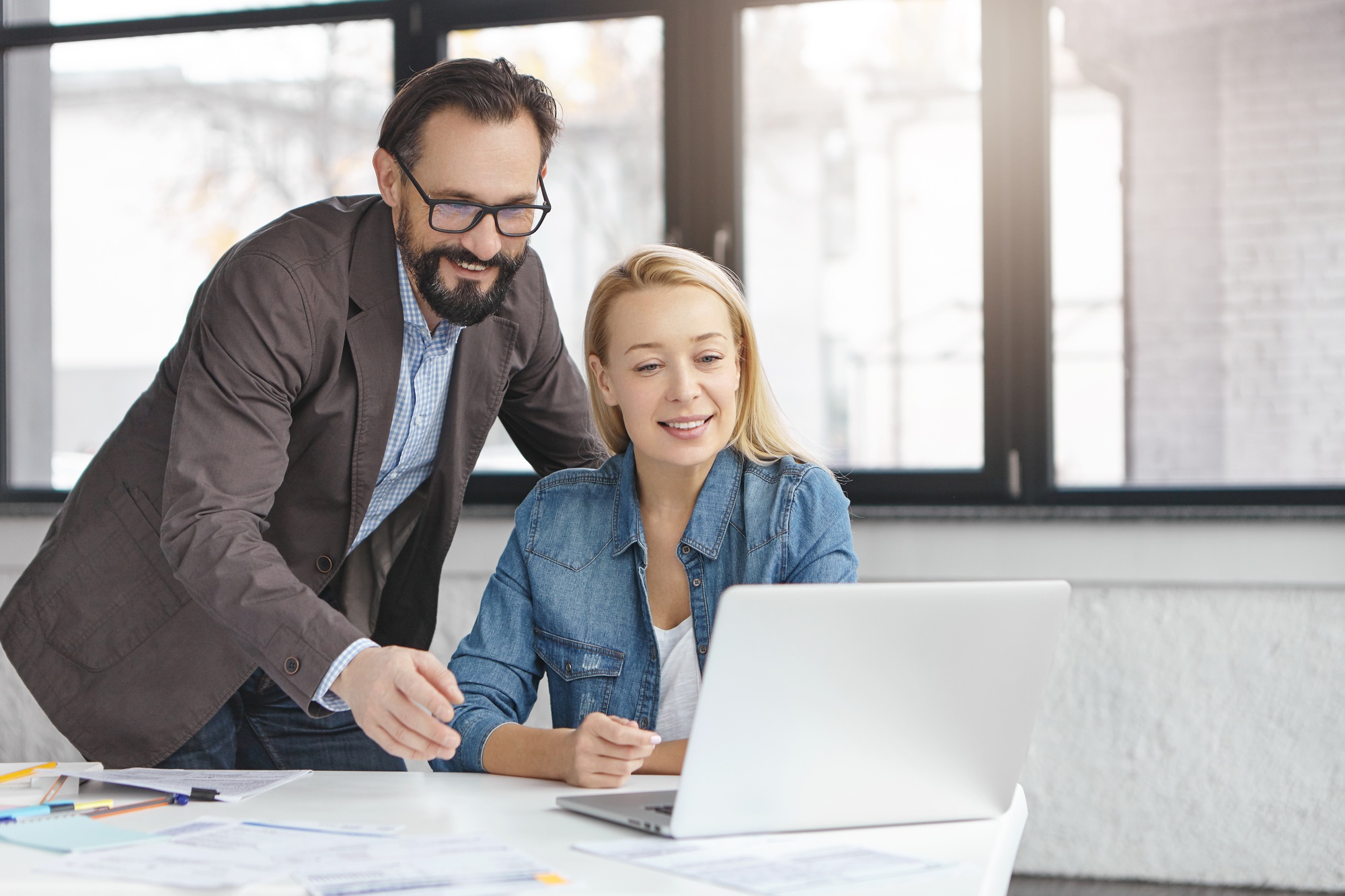 Image of talented female and male coworkers search information in network for future startup project