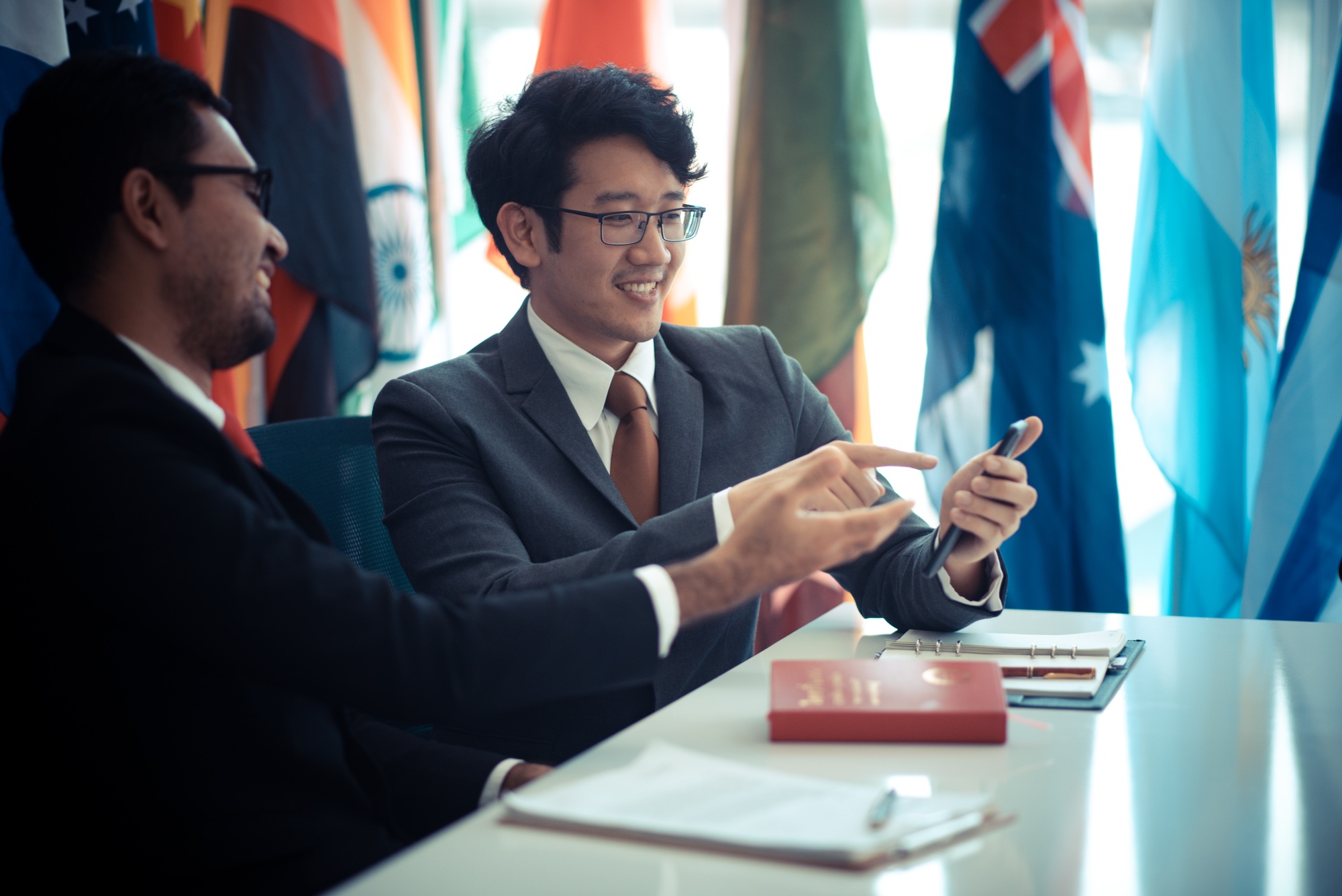 Image of two young businessmen at meeting