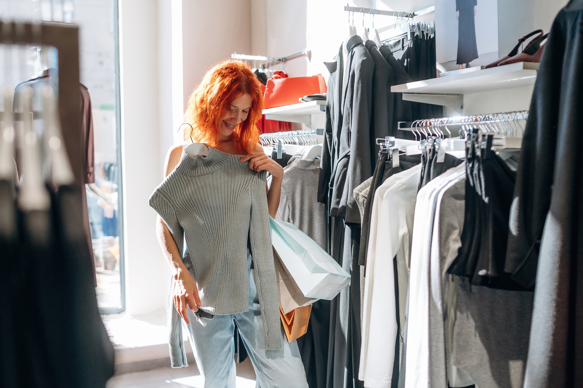 In retail store. Woman chooses clothes