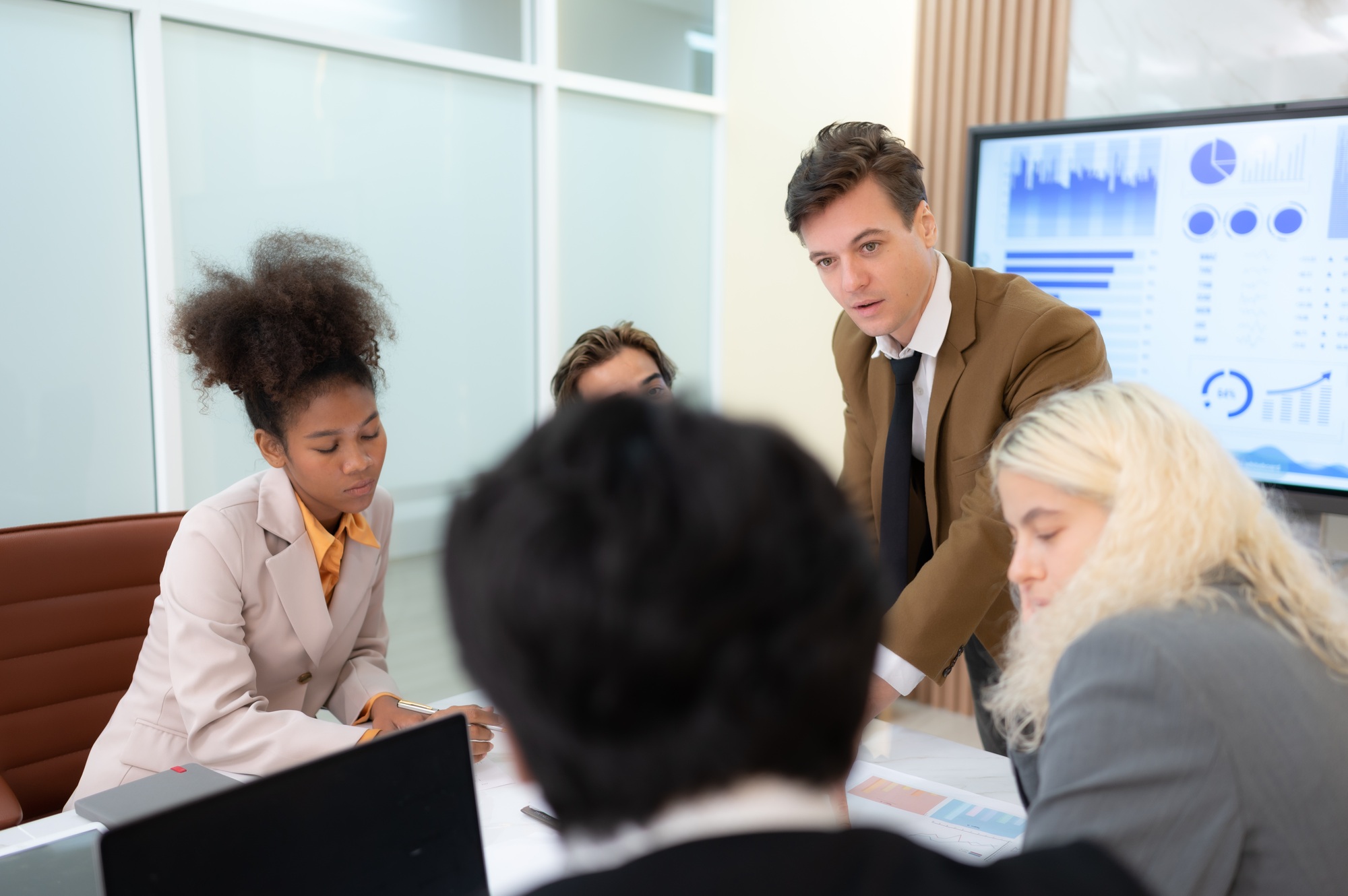 In the meeting room of an international business corporation,