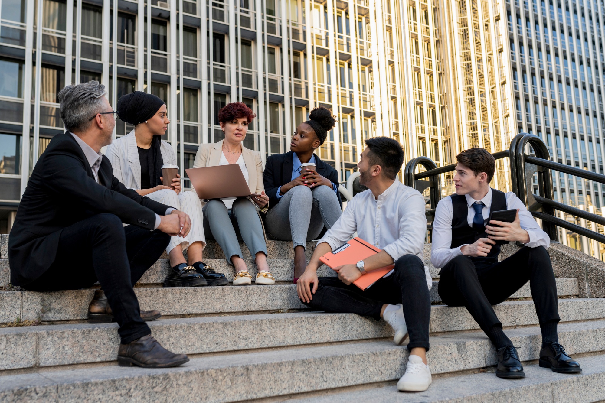 Inclusive Corporate Meeting: Diverse Team Collaborating on Steps