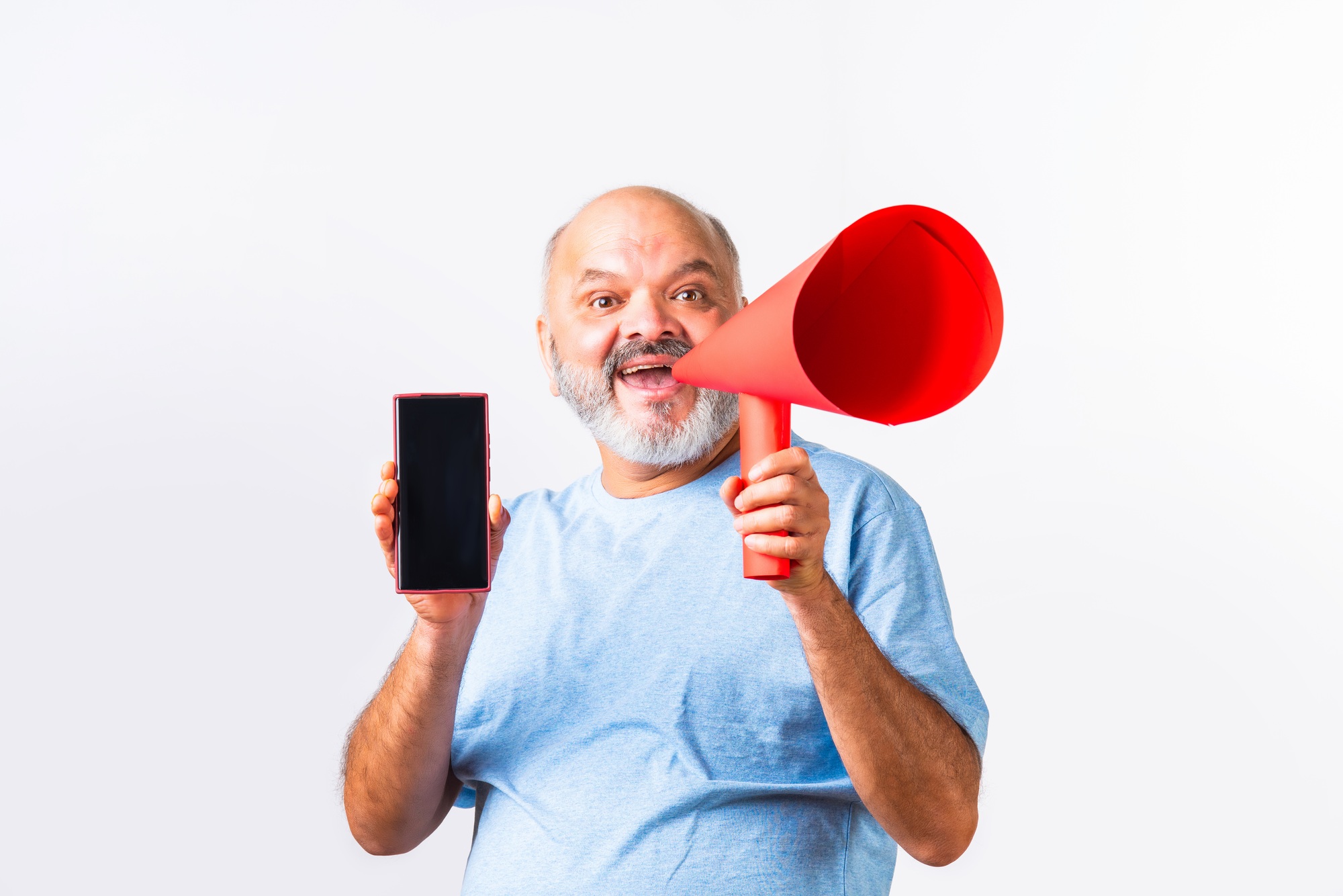 Indian asian elderly senior man promoting mobile app or offer using paper megaphone