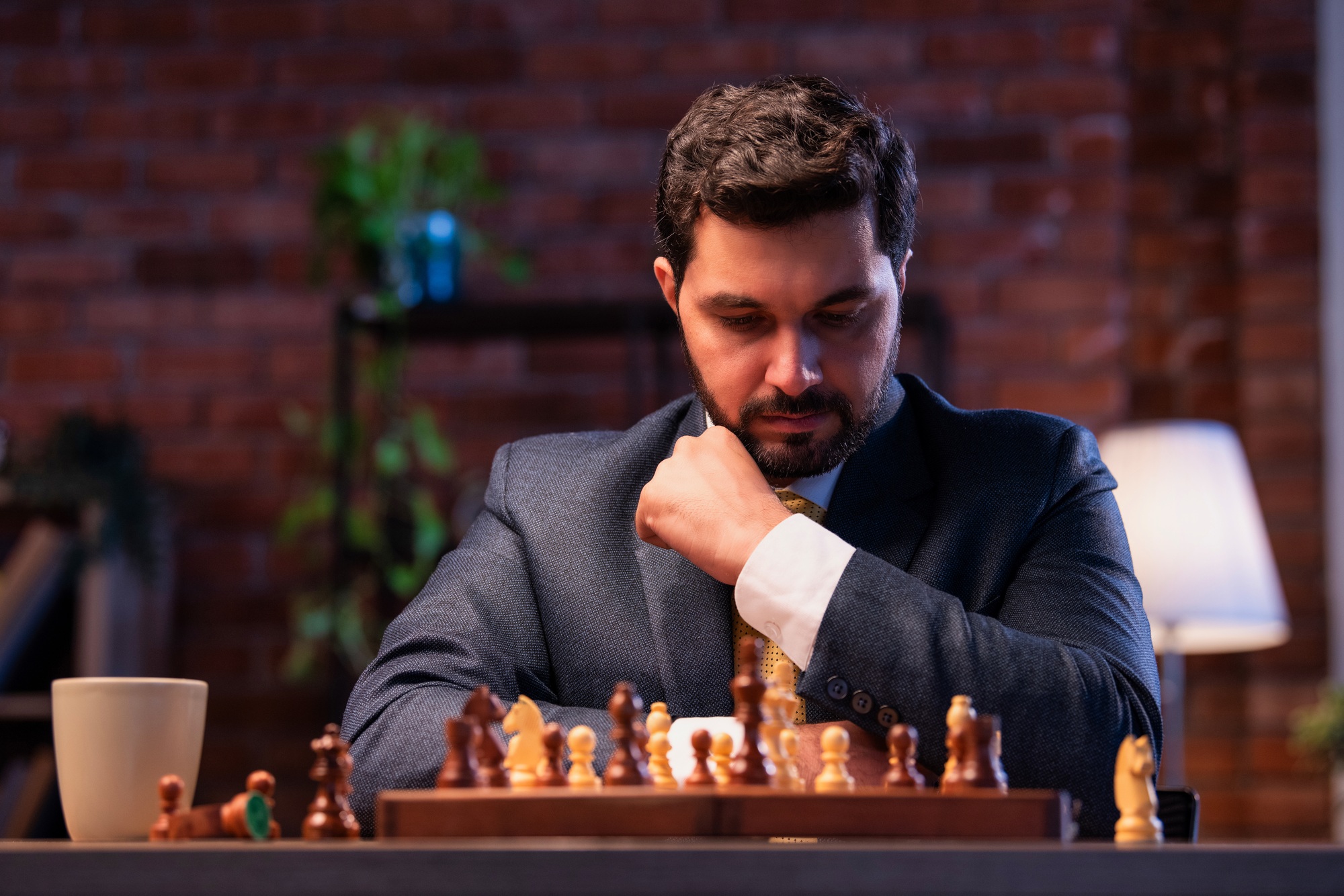 Indian executive playing chess in office, symbolizing business strategy and leadership planning
