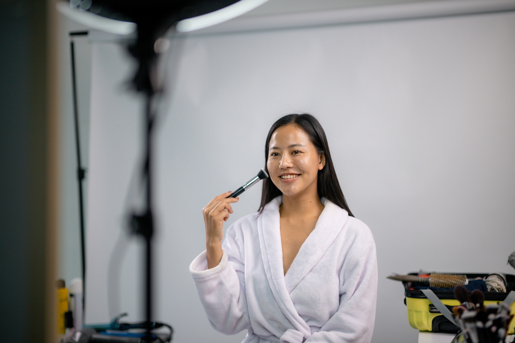 Influencer applying makeup and creating beauty content for social media