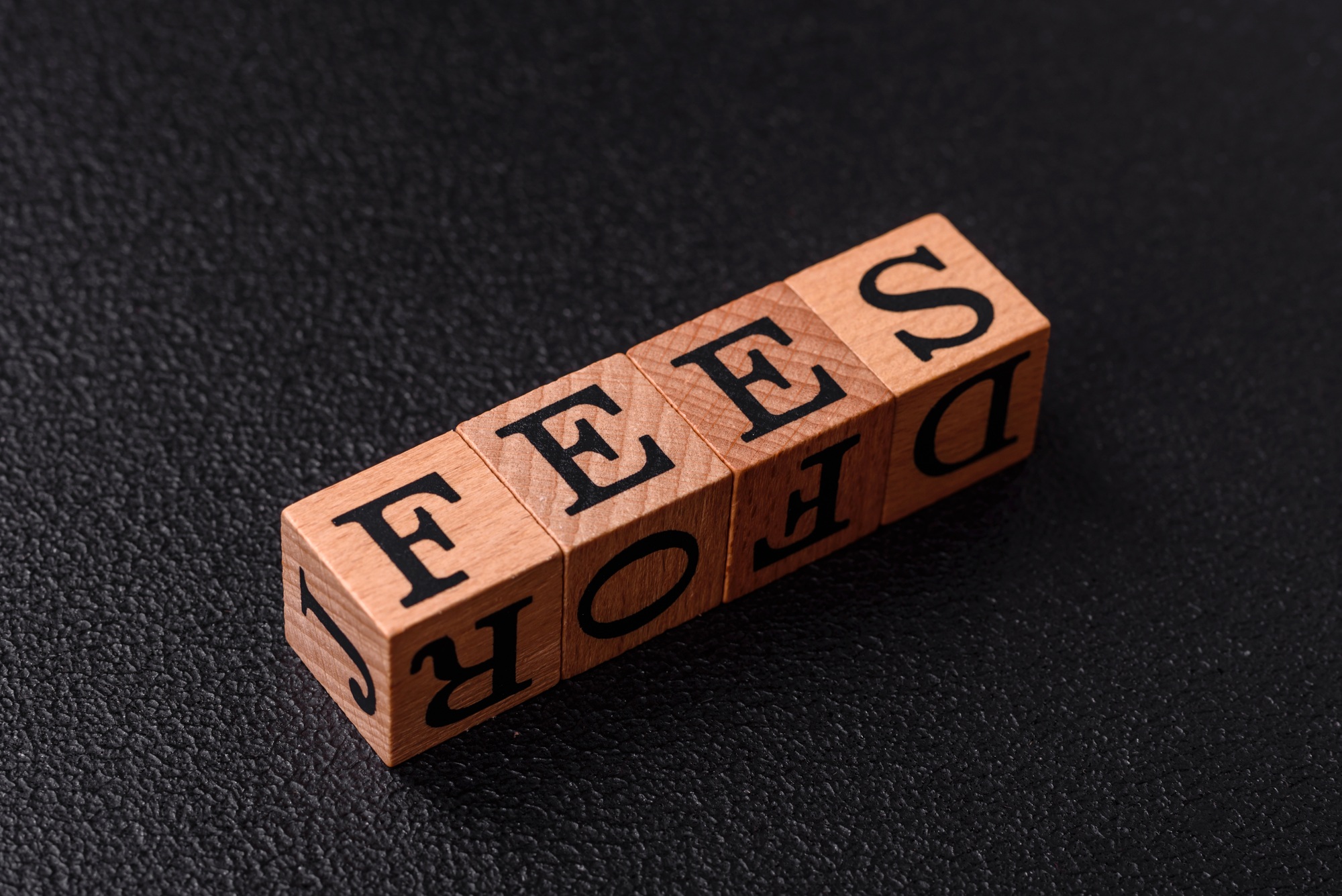 Inscription Fees with wooden cubes, conceptual background with copy space