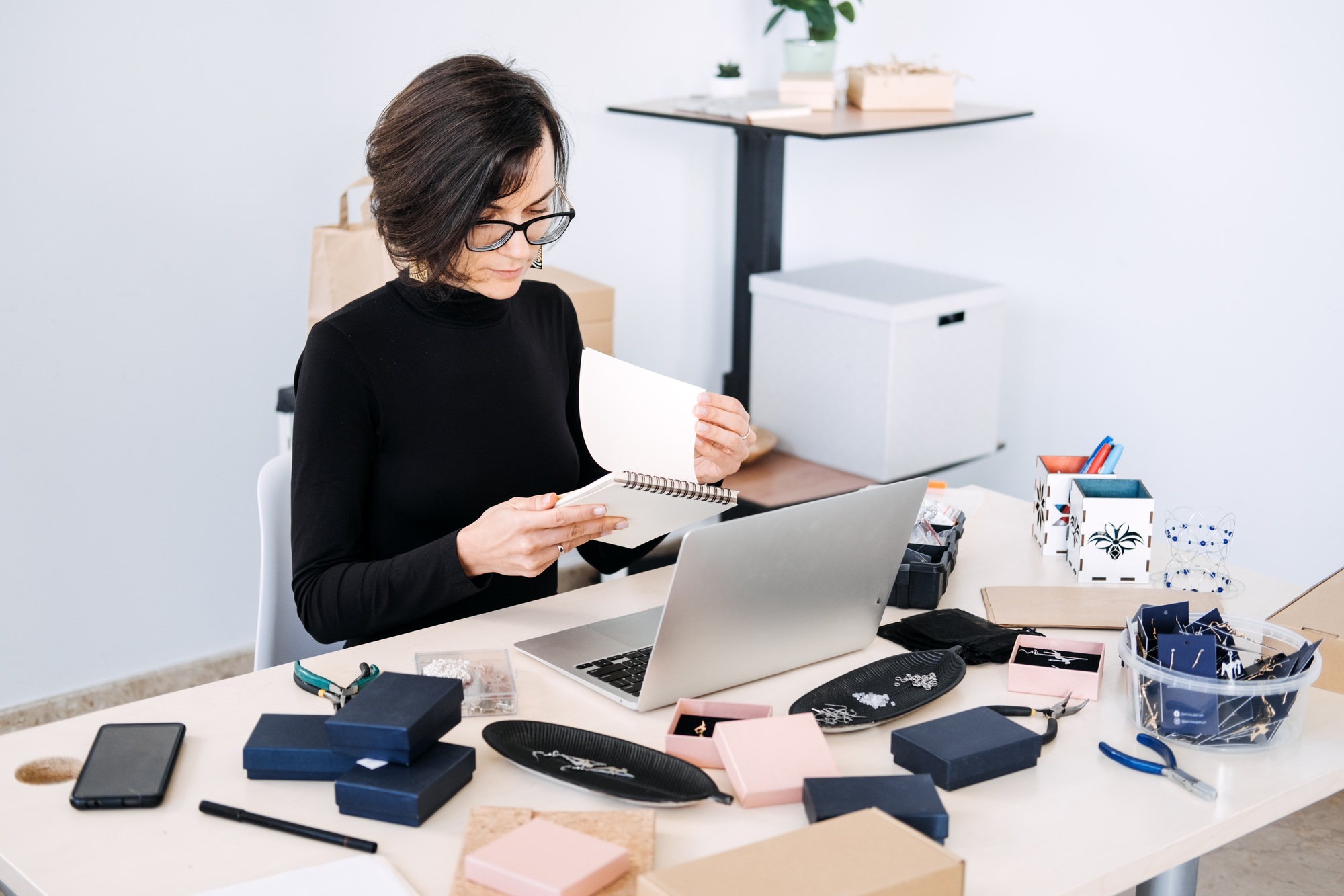 Jewelry business owner planning and organizing online sales strategy. Handmade brand management